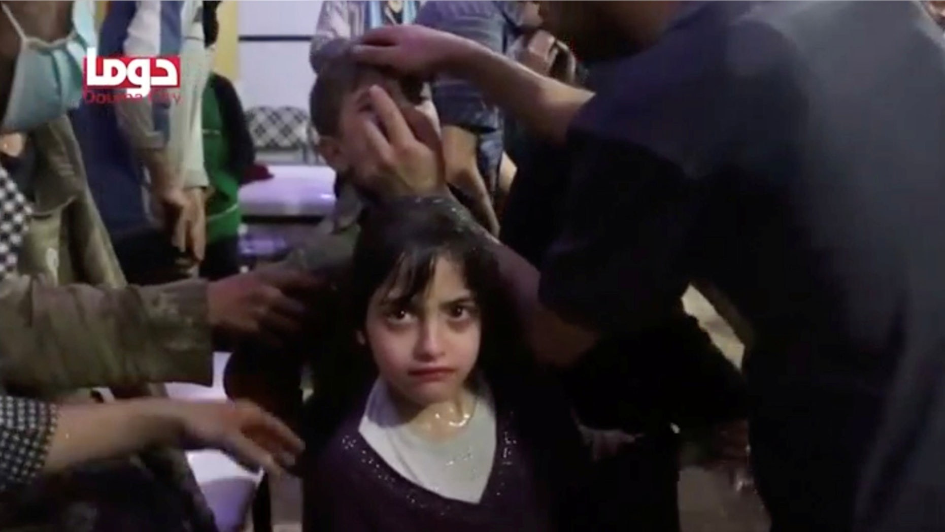 April 8: A girl looks on following alleged chemical weapons attack, in what is said to be Douma, Syria