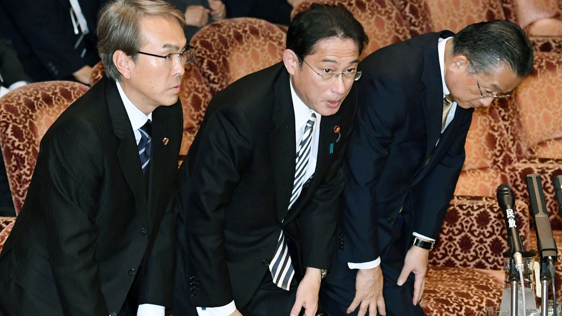 Japanese Economic Revitalization Minister Nobuteru Ishihara, Foreign Minister Fumio Kishida and Agriculture Minister Yuji Yamamoto, from left, bow after the Trans-Pacific Partnership (TPP) was approved during a special committee at the parliament's upper house in Tokyo Friday, Dec. 9, 2016.