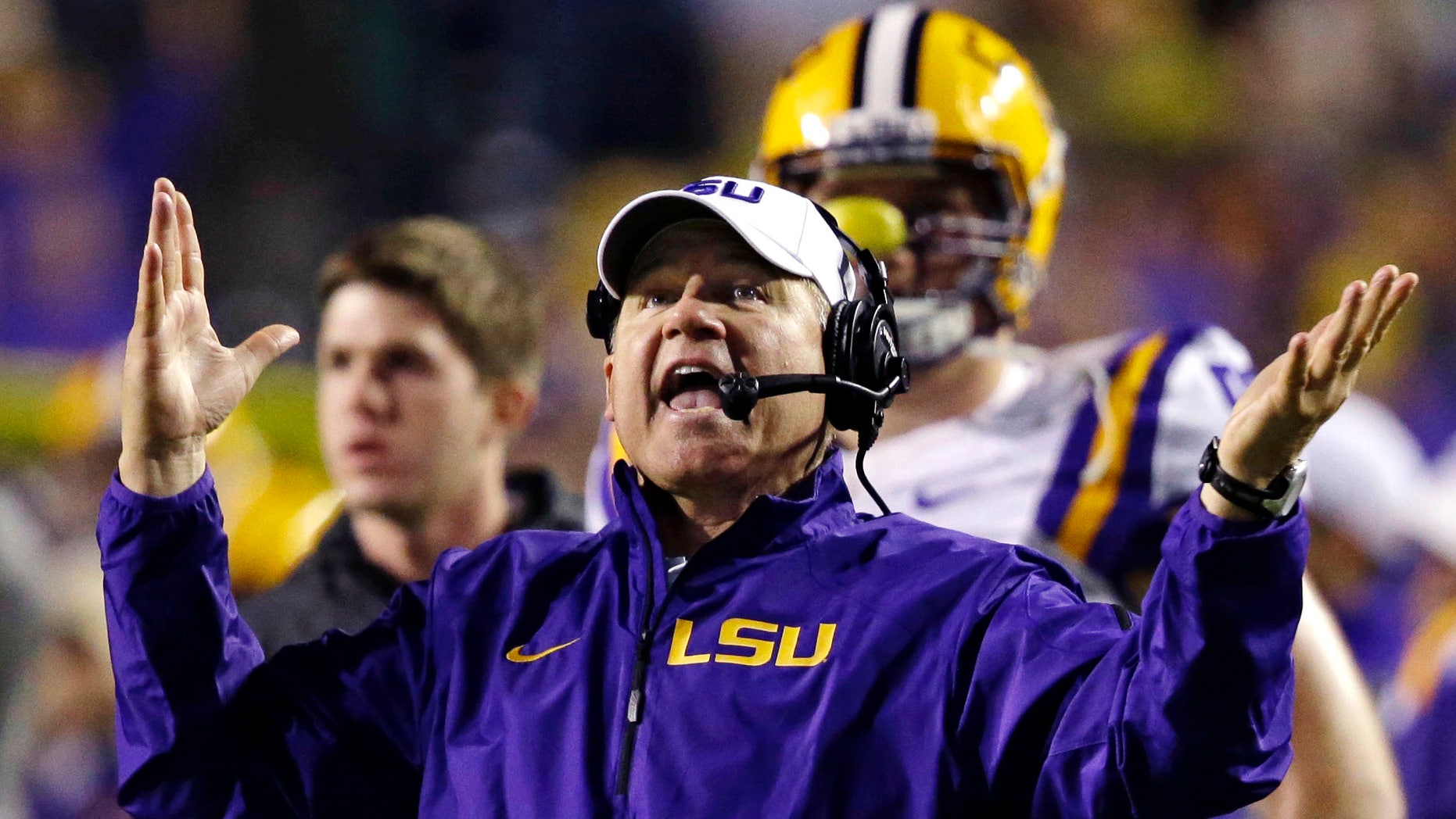 FILE - In this Nov. 23, 2013, file photo, LSU head coach Les Miles reacts to a touchdown call for Texas A&M that was later overturned on replay during the second half of an NCAA college football game in Baton Rouge, La. Recruiting is the lifeline of college coaches and with teenagers using social media like Twitter to communicate, some football staffs have pushed the boundaries of NCAA regulations to reach top high school recruits. Miles was reminded by LSU administration officials to use caution when taking to Twitter to discuss recruiting. National Signing Day is Wednesday, Feb. 5. (AP Photo/Gerald Herbert, File)