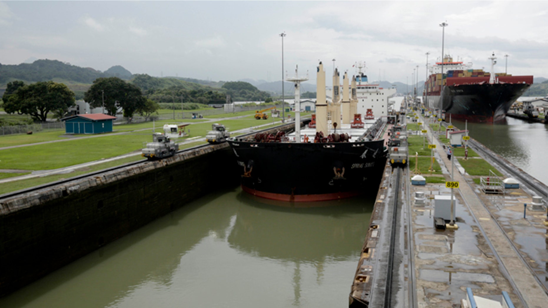 In this Aug. 4, 2014, photo, two cargo ships sails though the Miraflores locks on the Panama Canal in Panama City. (AP Photo/Arnulfo Franco)