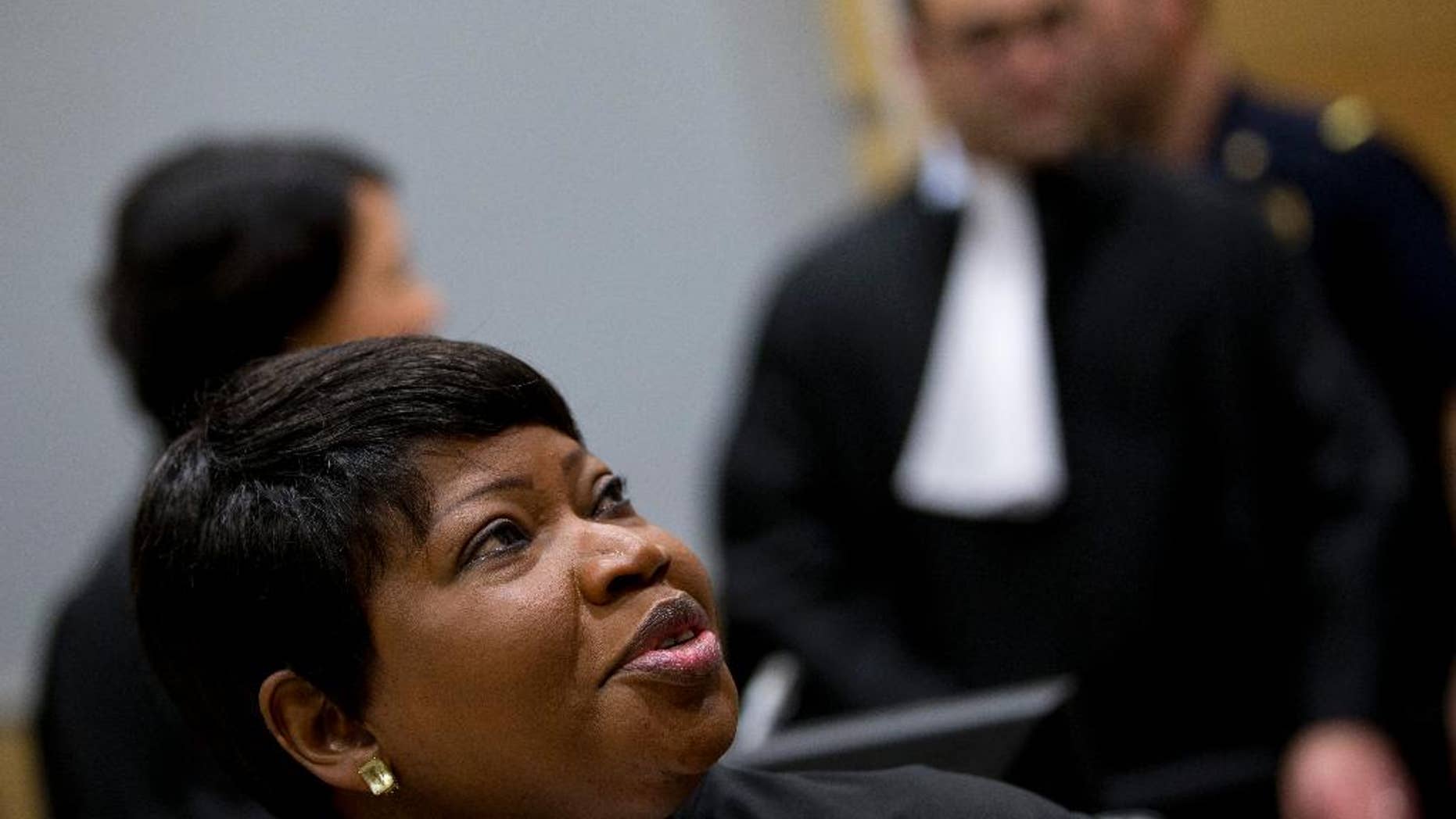 Prosecutor Fatou Bensouda of Gambia looks up as she waits for the start of the proceedings against Dominic Ongwen, a Ugandan commander in warlord Joseph Kony's feared militia, made his first appearance before judges at the International Criminal Court in The Hague, Netherlands, Monday, Jan. 26, 2015. Ongwen arrived in The Hague last week after being taken into custody in Central African Republic. He faces war crimes and crimes against humanity charges for his alleged role in a reign of terror that has spanned more than 25 years in central Africa's Great Lakes region. (AP Photo/Peter Dejong, Pool)