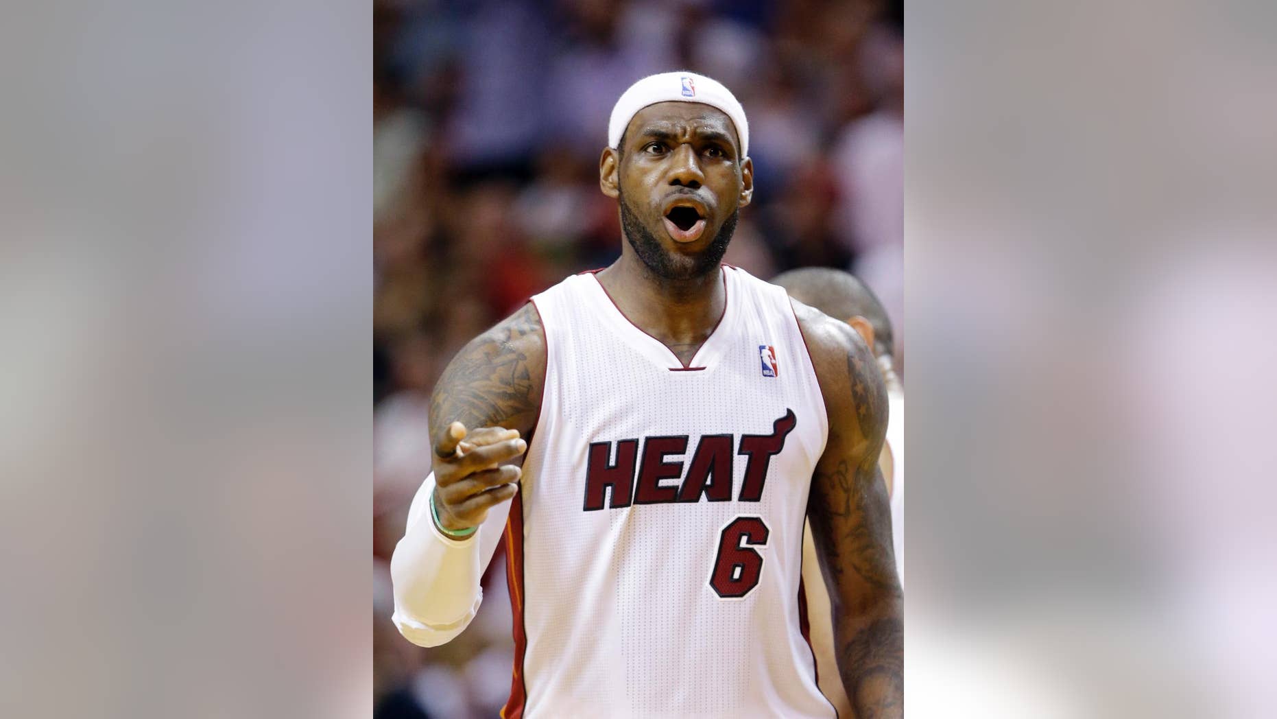 Miami Heat forward LeBron James celebrates after scoring during the second half of an NBA basketball game against the New York Knicks, Sunday, April 6, 2014, in Miami. James scored 38 points as the Heat defeated the Knicks 102-91. (AP Photo/Wilfredo Lee)
