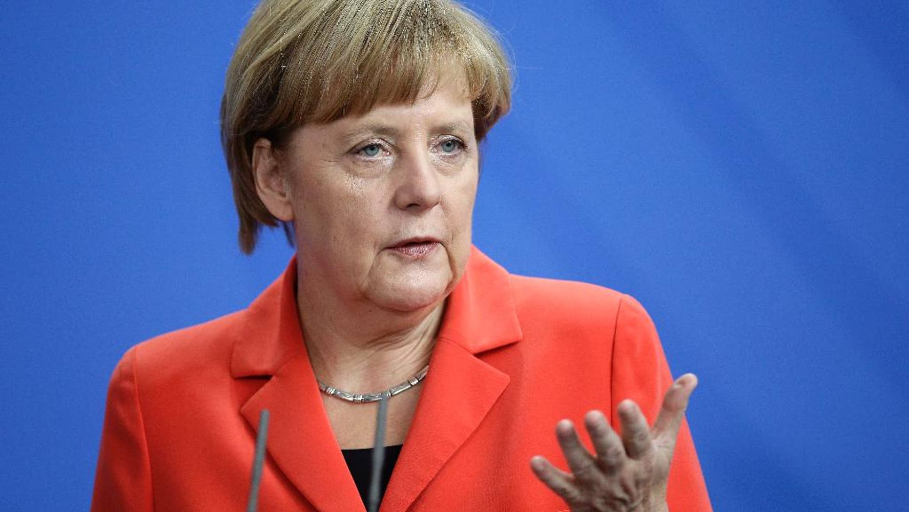German Chancellor Angela Merkel addresses the media during a joint news conference with Prime Minister of France Manuel Valls, as part of a meeting at the chancellery in Berlin, Germany, Monday, Sept. 22, 2014. (AP Photo/Michael Sohn)