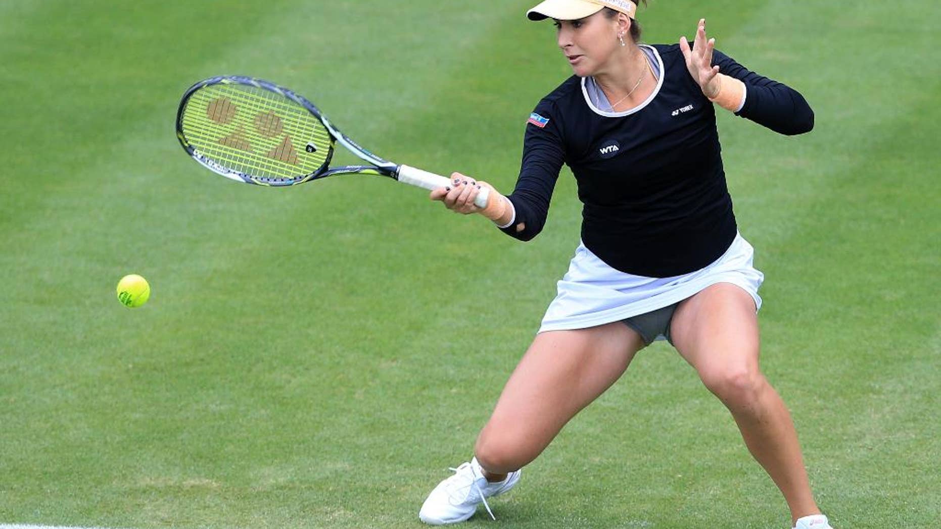 Switzerland's Belinda Bencic returns to Romania's Irina-Camelia Begu during day three of the Birmingham Classic women's tennis tournament at the Edgbaston Priory, Birmingham central England Wednesday June 15, 2016. ((Tim Goode/PA via AP) UNITED KINGDOM OUT