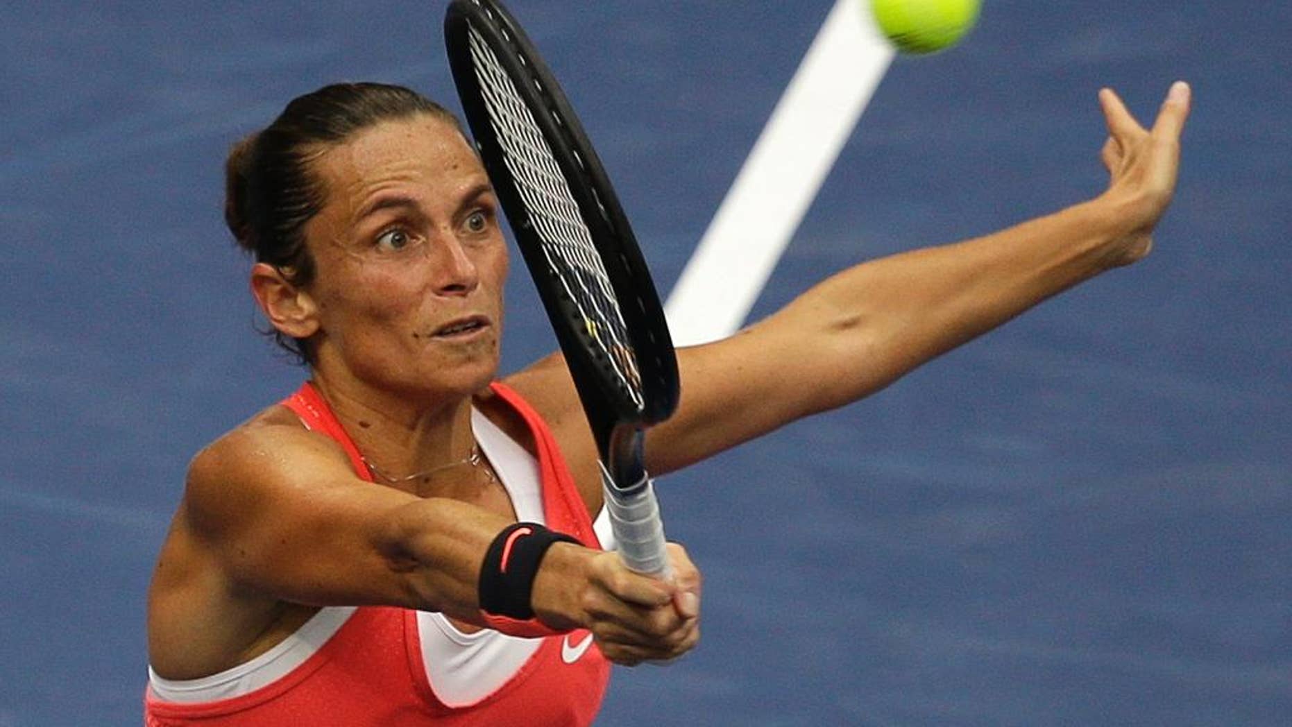 FILE -- In this Sept. 12, 2015 file photo, Roberta Vinci, of Italy, returns a shot to Flavia Pennetta, of Italy, during the women's championship match of the U.S. Open tennis tournament in New York. Seven months after ending Serena Williams' bid for a calendar-year Grand Slam in the semifinals of the U.S. Open, Vinci will be the local favorite at the Italian Open this week. (AP Photo/Seth Wenig)