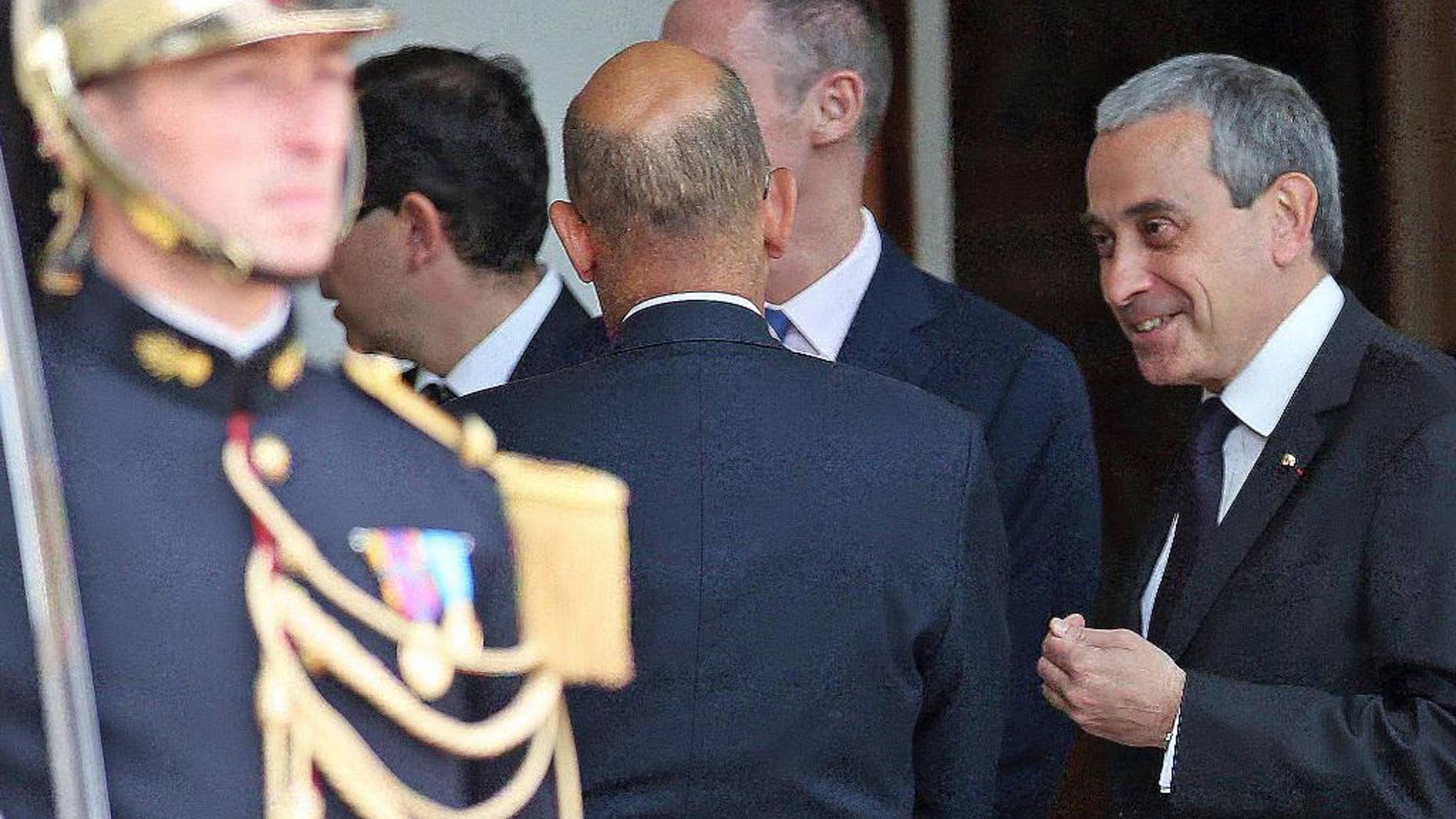FILE - In this June 2, 2015 file photo chief of protocol at the French presidential palace, Laurent Stefanini, right, speaks with an unidentified person at the Elysee Palace in Paris. France’s government has named a respected diplomat who is said to be gay as the country’s ambassador to UNESCO, several months after he was nominated as ambassador to the Vatican _ a job he never started. (AP Photo/Remy de la Mauviniere, File)