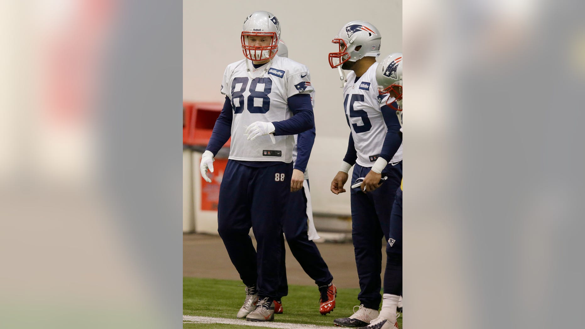 New England Patriots tight ends D.J. Williams (45) and Matthew Mulligan (88) talk during a drills and stretching session before practice begins at the NFL football team's facility in Foxborough, Mass., Wednesday, Dec. 11, 2013. The Patriots will play the Miami Dolphins in Miami, Sunday. (AP Photo/Stephan Savoia)
