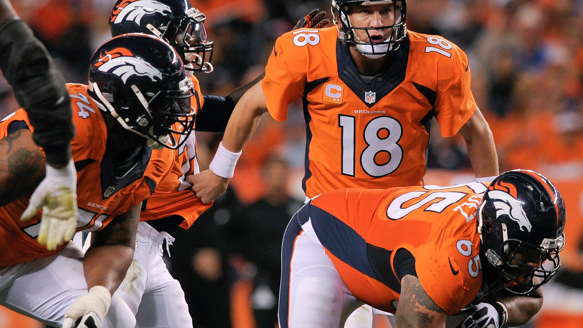 FILE - In this Sept. 23, 2013, file photo, Denver Broncos quarterback Peyton Manning (18) directs running back Knowshon Moreno (27), behind offensive lineen Orland Franklin (74) and Louis Vasquez (65), during the third quarter of an NFL football game against the Oakland Raiders in Denver. (AP Photo/Jack Dempsey, File)