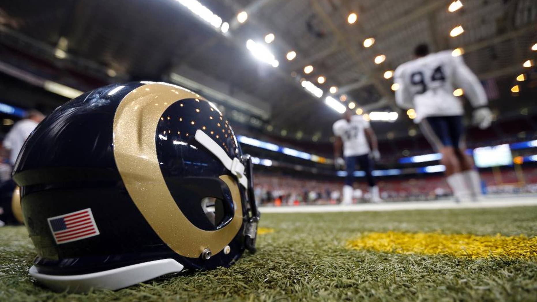 St. Louis Rams defensive end Robert Quinn, right, and Eugene Sims take part in a drill during NFL football training camp at Edward Jones Dome Saturday, Aug. 2, 2014, in St. Louis. (AP Photo/Jeff Roberson)