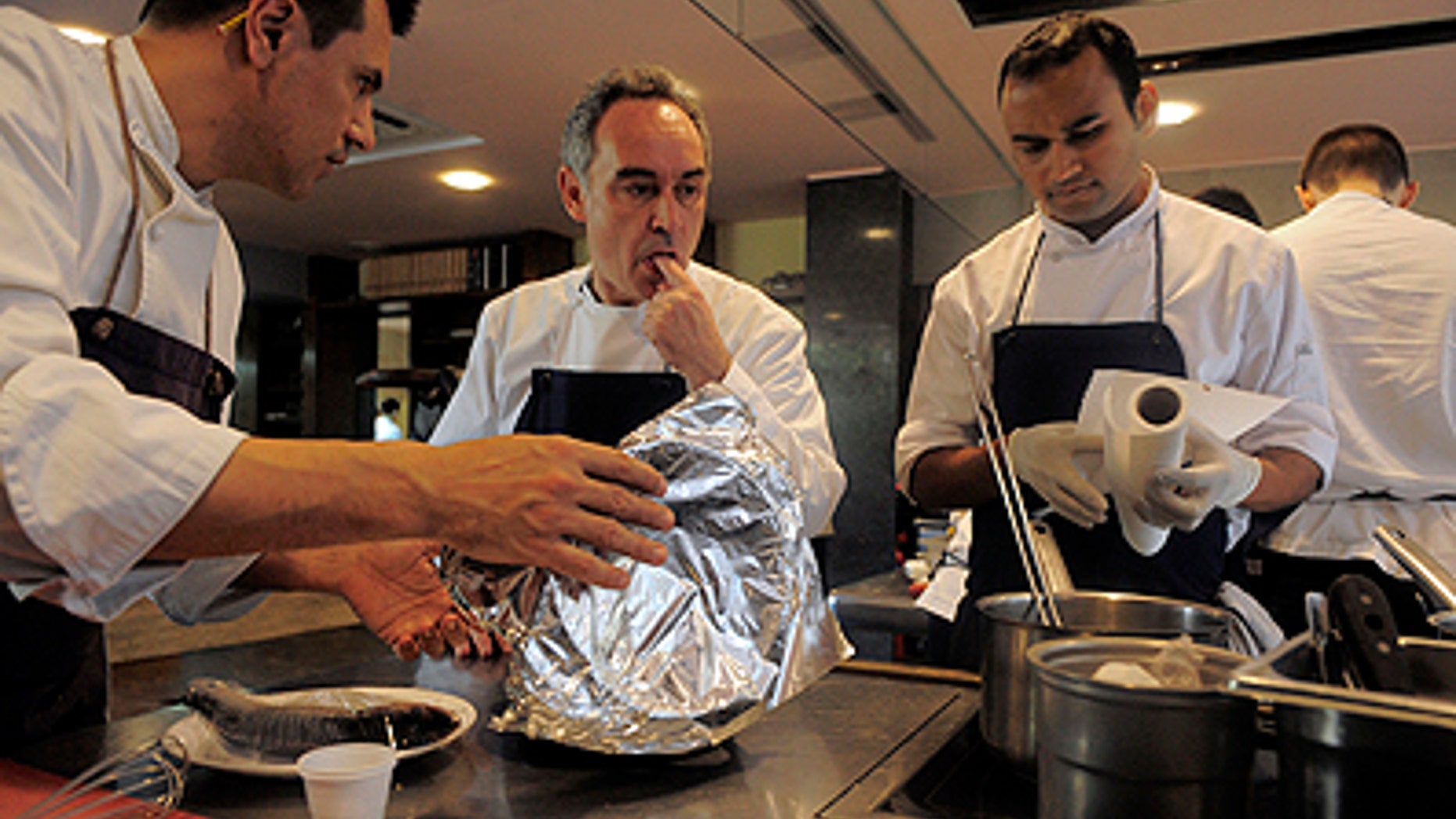 This March 30, 2011 photo shows Spanish chef Ferran Adria as he tastes some food in the kitchen of his restaurant elBulli in Roses, Spain. The oft-imitated, modernist wizardry that Adria has pioneered for nearly 20 years in Spain's far northeastern tip has earned him fame, awards and the highest of honors. (AP Photo/Manu Fernandez)