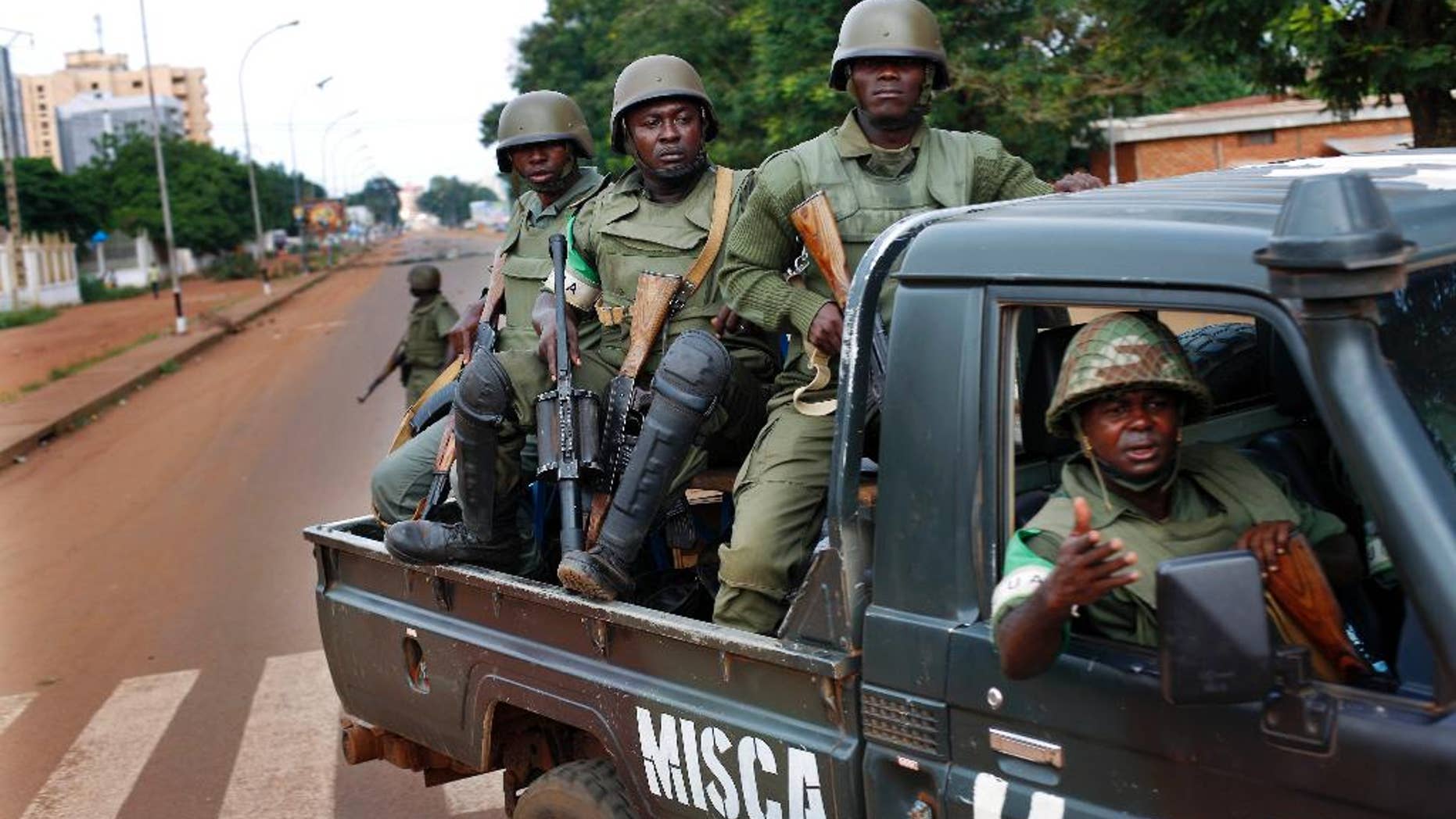 FILE-In this file photo taken on Thursday, May 29, 2014, African Union MISCA troops from Cameroon patrol in Bangui, Central African Republic. The United Nations took over a regional African peacekeeping mission in Central African Republic on Monday, Sept. 15, nine months after sectarian violence erupted that has left at least 5,000 people dead and has forced tens of thousands of Muslims to flee into exile in neighboring countries. (AP Photo/Jerome Delay,File)