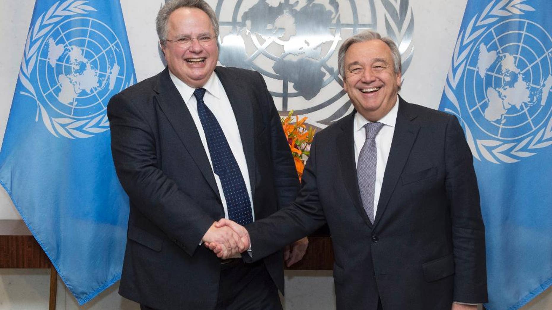 In this photo provided by the United Nations, U.N. Secretary-General Antonio Guterres, right, shakes hands with Greek Foreign Minister Nikos Kotzias at U.N. headquarters, Friday, Jan. 6, 2017. (Eskinder Debebe/The United Nations via AP)