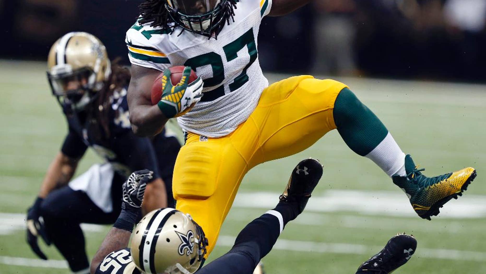 FILE - In this Oct. 26, 2014, file photo, Green Bay Packers running back Eddie Lacy (27) carries over fallen New Orleans Saints free safety Rafael Bush (25) in the second half of an NFL football game in New Orleans. Lacy is rolling over defenders. Aaron Rodgers is rolling in general. The Packers have climbed into a first-place tie in the NFC North by winning six of their last seven games. (AP Photo/Rogelio Solis, File)