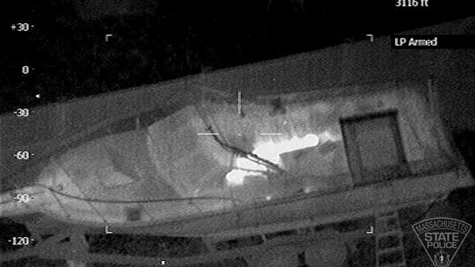 This Friday, April 19, 2013 image made available by the Massachusetts State Police shows 19-year-old Boston Marathon bombing suspect, Dzhokhar Tsarnaev, hiding inside a boat during a search for him in Watertown, Mass. He was pulled, wounded and bloody, from the boat parked in the backyard of a home in the Greater Boston area. Two U.S. officials say the surviving suspect in the Boston bombings was unarmed when police captured him hiding inside a boat in a neighborhood back yard. Authorities originally said they had exchanged gunfire with Dzhokhar Tsarnaev for more than one hour Friday evening before they were able to subdue him. (AP Photo/Massachusetts State Police)