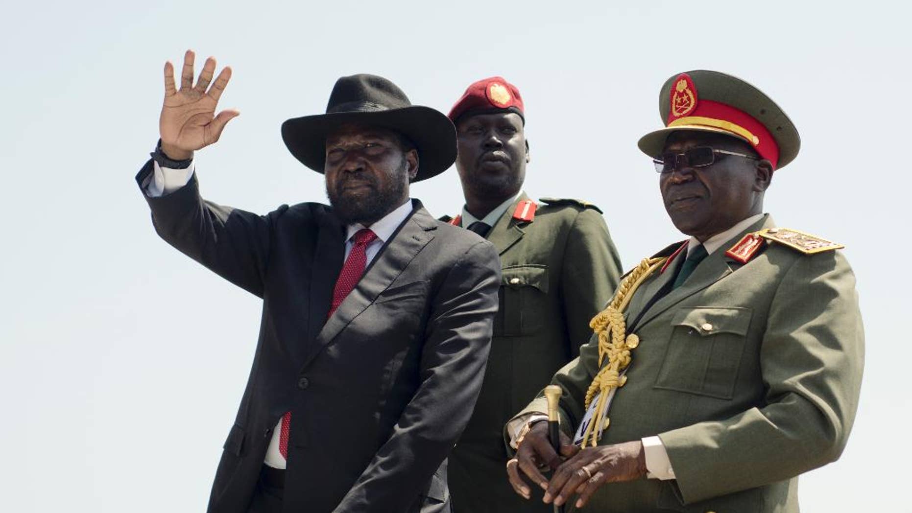FILE - In this Thursday, July 9, 2015 file photo, South Sudan's President Salva Kiir, left, accompanied by army chief of staff Paul Malong, right, waves during an independence day ceremony in the capital Juba, South Sudan. A spokesman said Wednesday, Feb. 8, 2017 that Kiir will seek election next year, in what will be the first vote on Salva Kiir's leadership since the turbulent country won independence. (AP Photo/Jason Patinkin, File)