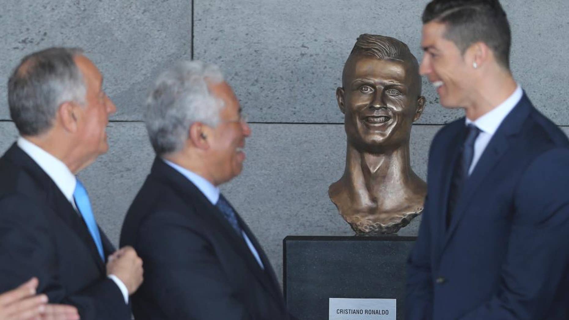 Portuguese president Marcelo Rebelo de Sousa, left, Portuguese Prime Minister Antonio Costa and Cristiano Ronaldo standing next to the bust Wednesday.