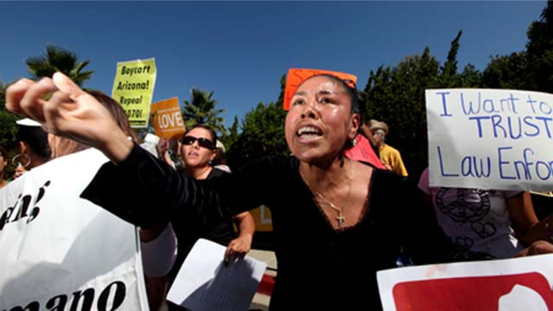 SAN DIEGO, CA - Aug 10: Olga Torres chants along with other people during a protest against Maricopa County Sheriff Joe Arpaio during his visit to the Rancho Bernardo Inn on Tueday, August 10, 2010 in Rancho Bernardo, California. Arpaio, who is Sheriff of Maricopa County in Arizona, gained National attention by for using deputies to conduct raids to apprehend illegal immigrants and build large prison tents to house inmates.(Photo by Sandy Huffaker/Getty Images)