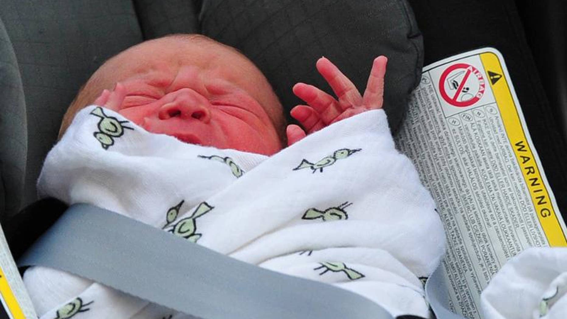 File picture taken on July 23, 2013 Prince William and Catherine, Duchess of Cambridge' new-born baby boy later named Prince George seen in a car seat outside the Lindo Wing of St Mary's Hospital in London.