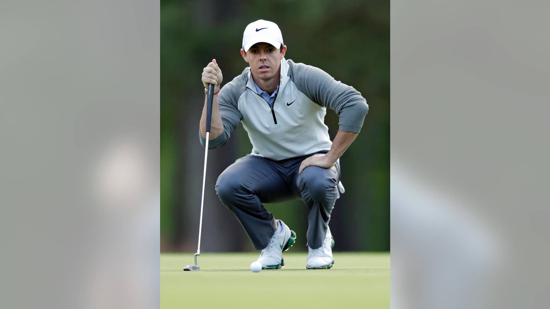 Rory McIlroy lines up a putt on the 11th hole during the first round of the Wells Fargo Championship golf tournament in Charlotte, N.C., Thursday, May 1, 2014. (AP Photo/Chuck Burton)