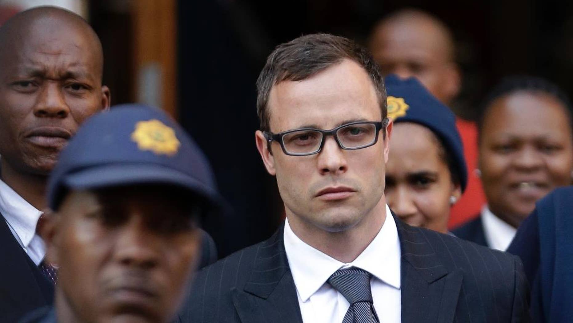 Oscar Pistorius, center, leaves the high court in Pretoria, South Africa, Thursday, Aug. 7, 2014. The chief prosecutor said Thursday the double-amputee athlete's lawyers have floated more than one theory in a dishonest attempt to defend against a murder charge for his killing of girlfriend Reeva Steenkamp. (AP Photo/Themba Hadebe)