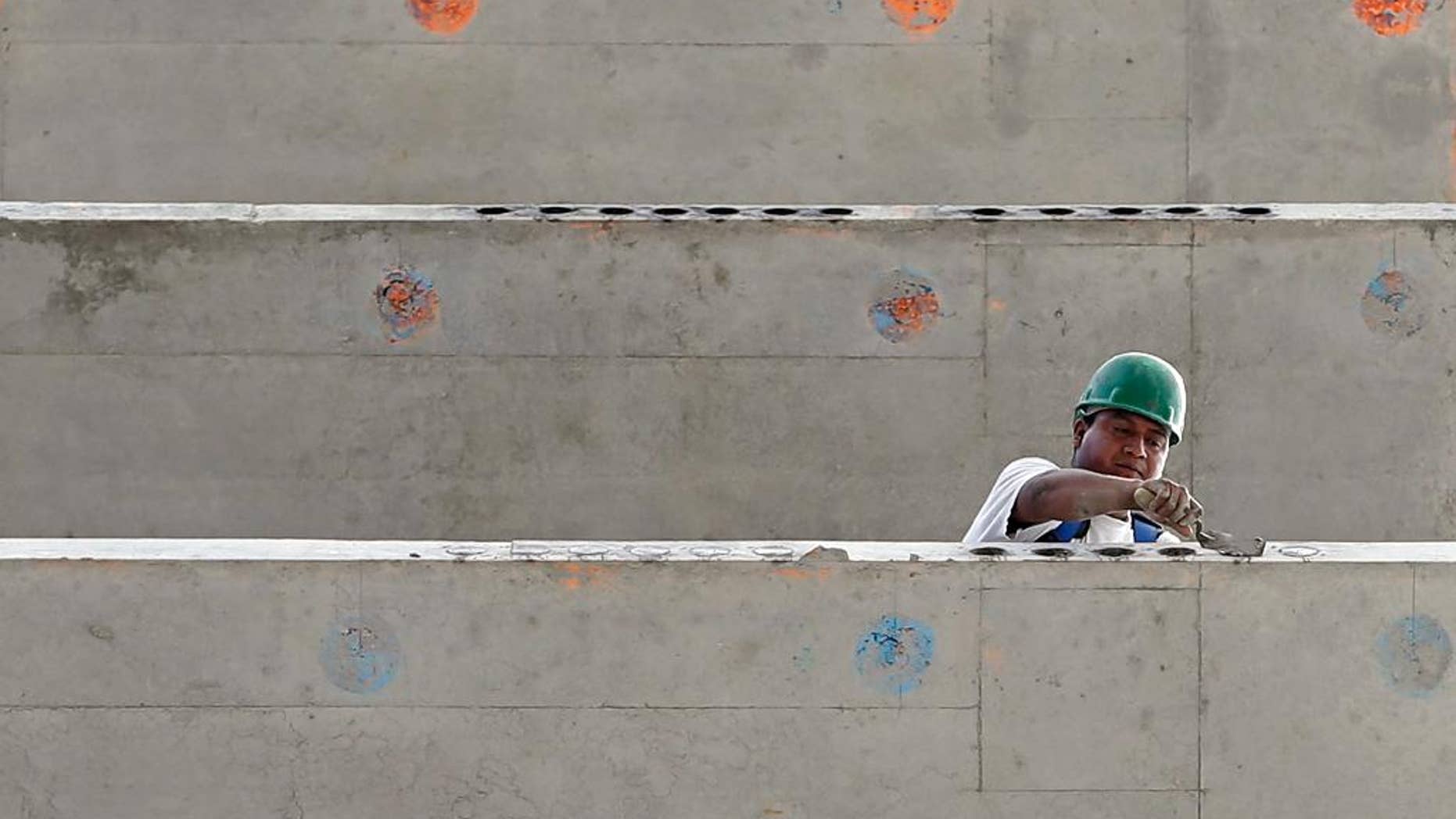In this photo taken July 22, 2014, a construction worker is seen on a 36 floor high rise condominium in Miami. The Commerce Department reports on U.S. construction spending in July on Tuesday, Sept. 2, 2014. (AP Photo/Alan Diaz)