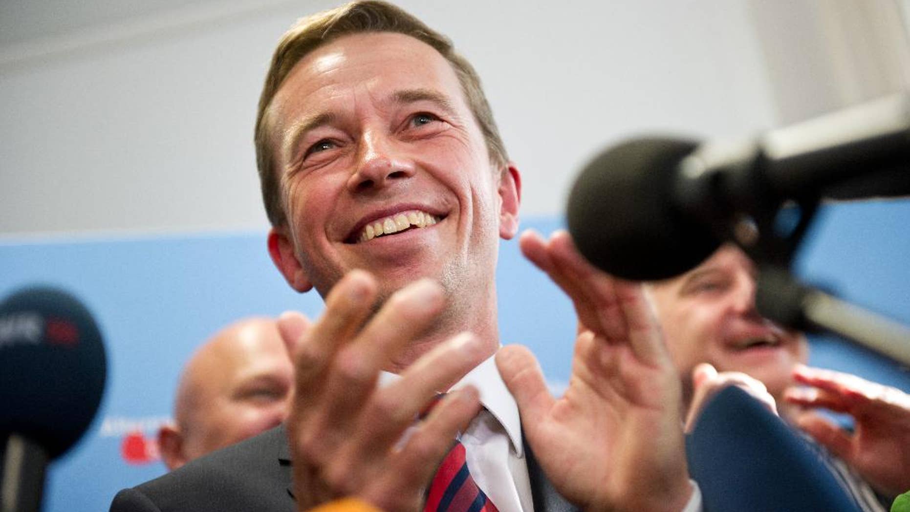 The head of the Alternative fuer Deutschland , AfD, party, Bernd Lucke, celebrates after the first exit polls for the Saxony State election , in Berlin, Sunday Aug. 31, 2014. Exit polls say the party that wants Germany to ditch the euro currency will be elected to a state assembly for the first time. The polls indicate that the party, Alternative for Germany, won 10 percent of the vote in Sunday's elections for the Saxony state parliament. (AP Photo/dpa, Daniel Naupold)