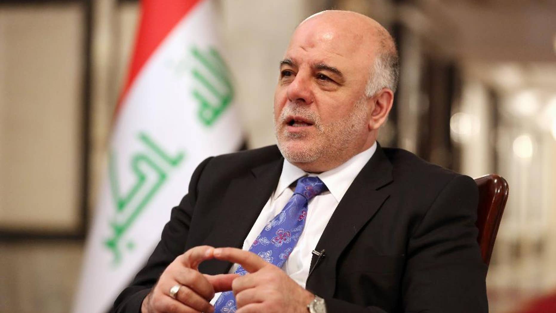 Iraq's Prime Minister Haider al-Abadi speaks during an interview with The Associated Press in Baghdad, Iraq, Wednesday, Sept. 17, 2014. Iraq’s new prime minister says foreign ground troops are neither necessary nor wanted in his country’s fight against the Islamic State group. (AP Photo/Hadi Mizban)
