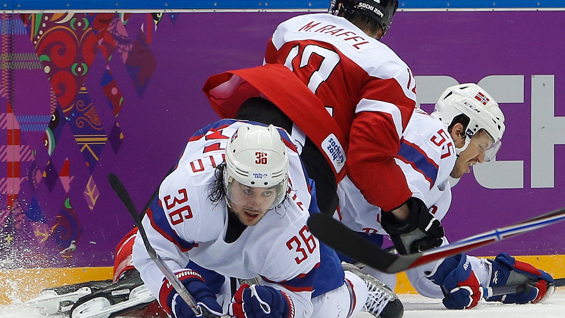 Norway forward Mats Zuccarello gets tangled up with Austria forward Michael Raffl (12) and Norway defenseman Ole-Kristian Tollefsen in the third period of a men's ice hockey game at the 2014 Winter Olympics, Sunday, Feb. 16, 2014, in Sochi, Russia. (AP Photo/Mark Humphrey)