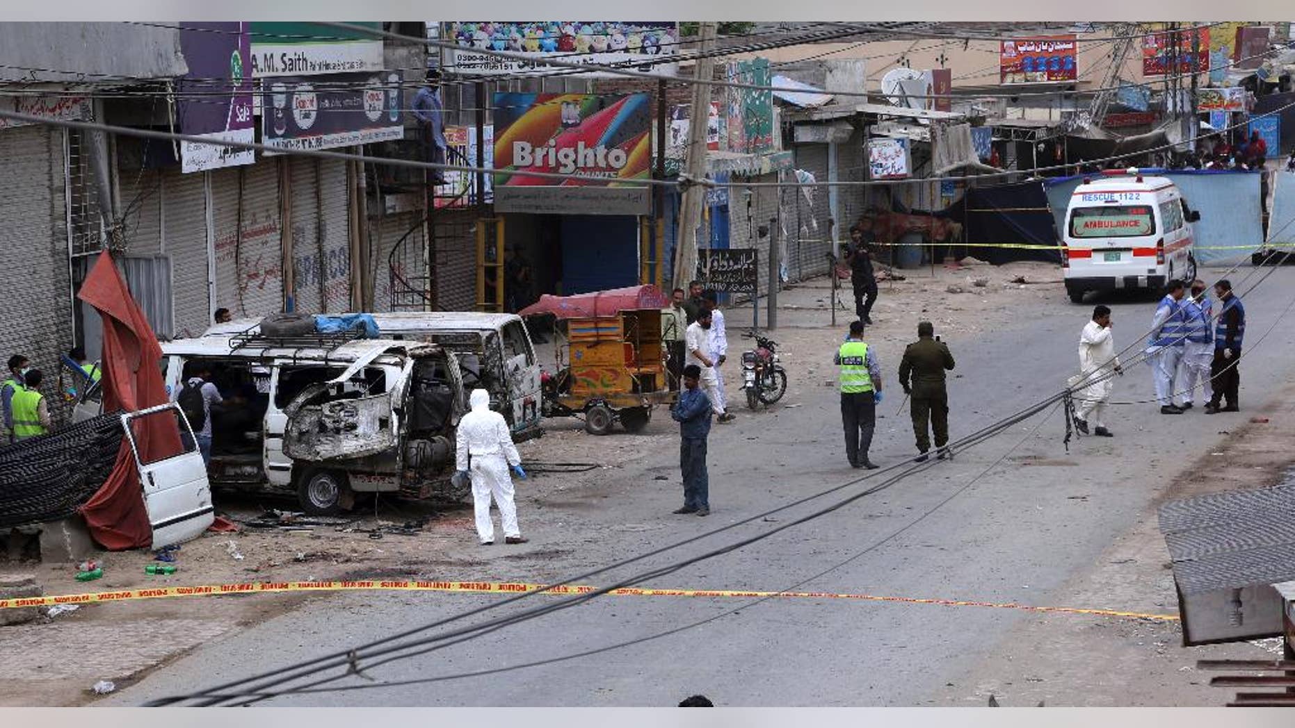 Pakistani investigators examine the site of a suicide bombing in Lahore.