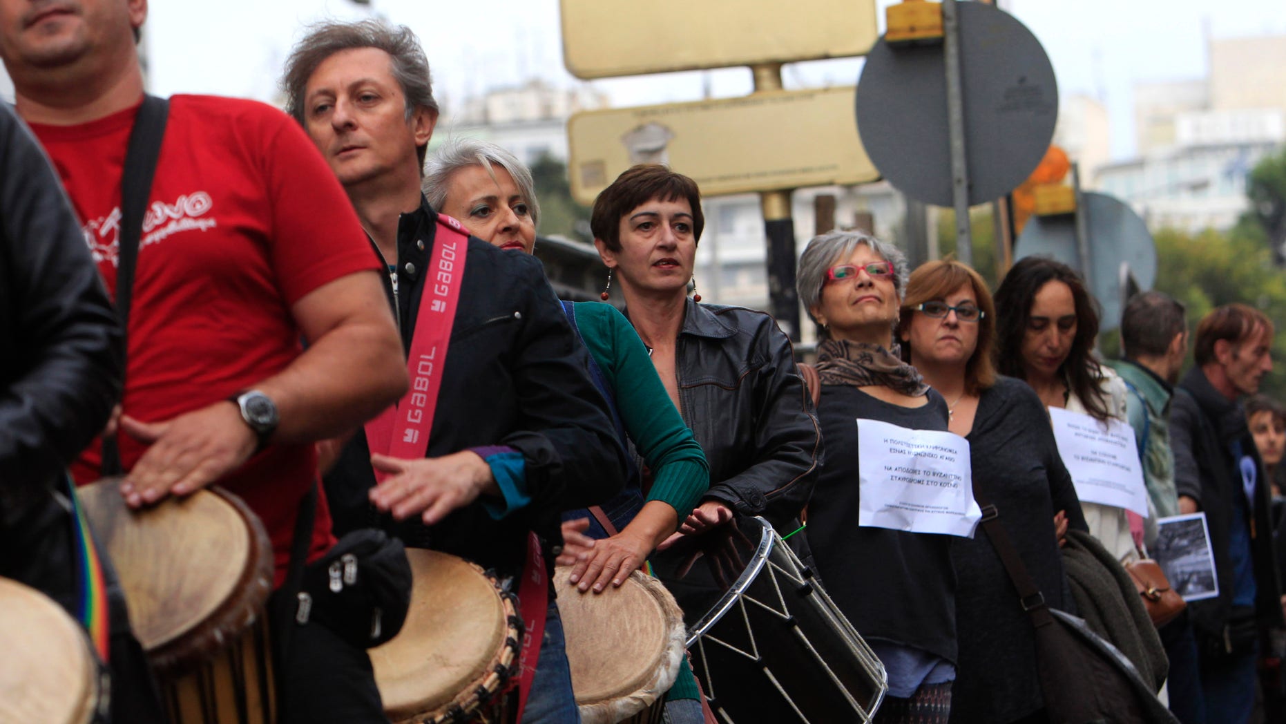 Demonstrators protest outside the construction site of a new subway station in Thessaloniki, Greece, on Monday Oct. 7 2013. Some 200 people, including many state-employed archaeologists, have protested Greek government plans to dig up a large section of an ancient Roman road, and move it elsewhere, to make way for a new subway station. Holding a banner reading “Culture is not business,” the demonstrators outside the construction site at the center of the northern city of Thessaloniki are calling for the stone road to be incorporated into the subway station. (AP Photo Nikolas Giakoumidis)