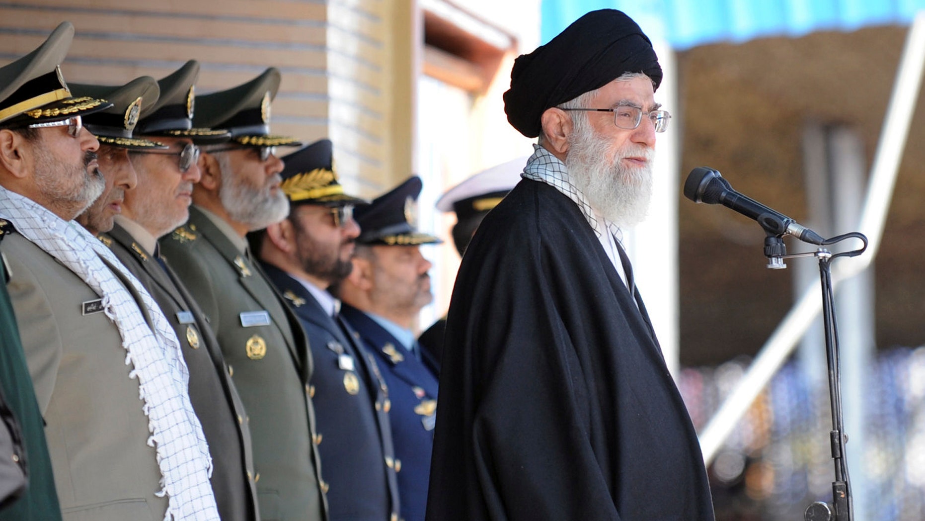 Nov. 10, 2011: Iranian supreme leader Ayatollah Ali Khamenei, right, stands at the podium in front of high ranking armed forces members, during a ceremony in a military university, in Tehran, Iran.