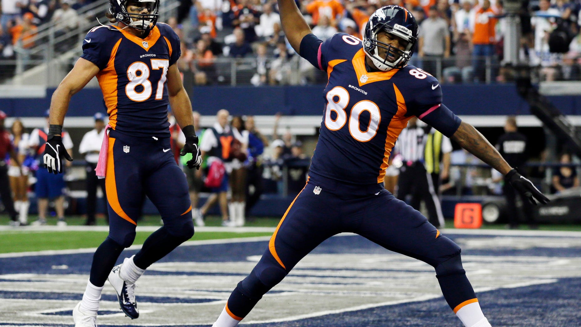 Denver Broncos tight end Julius Thomas (80) celebrates his touchdown against the Dallas Cowboys during the first quarter of an NFL football game Sunday, Oct. 6, 2013, in Arlington, Texas. Eric Decker (87) joins in. (AP Photo/Tony Gutierrez)