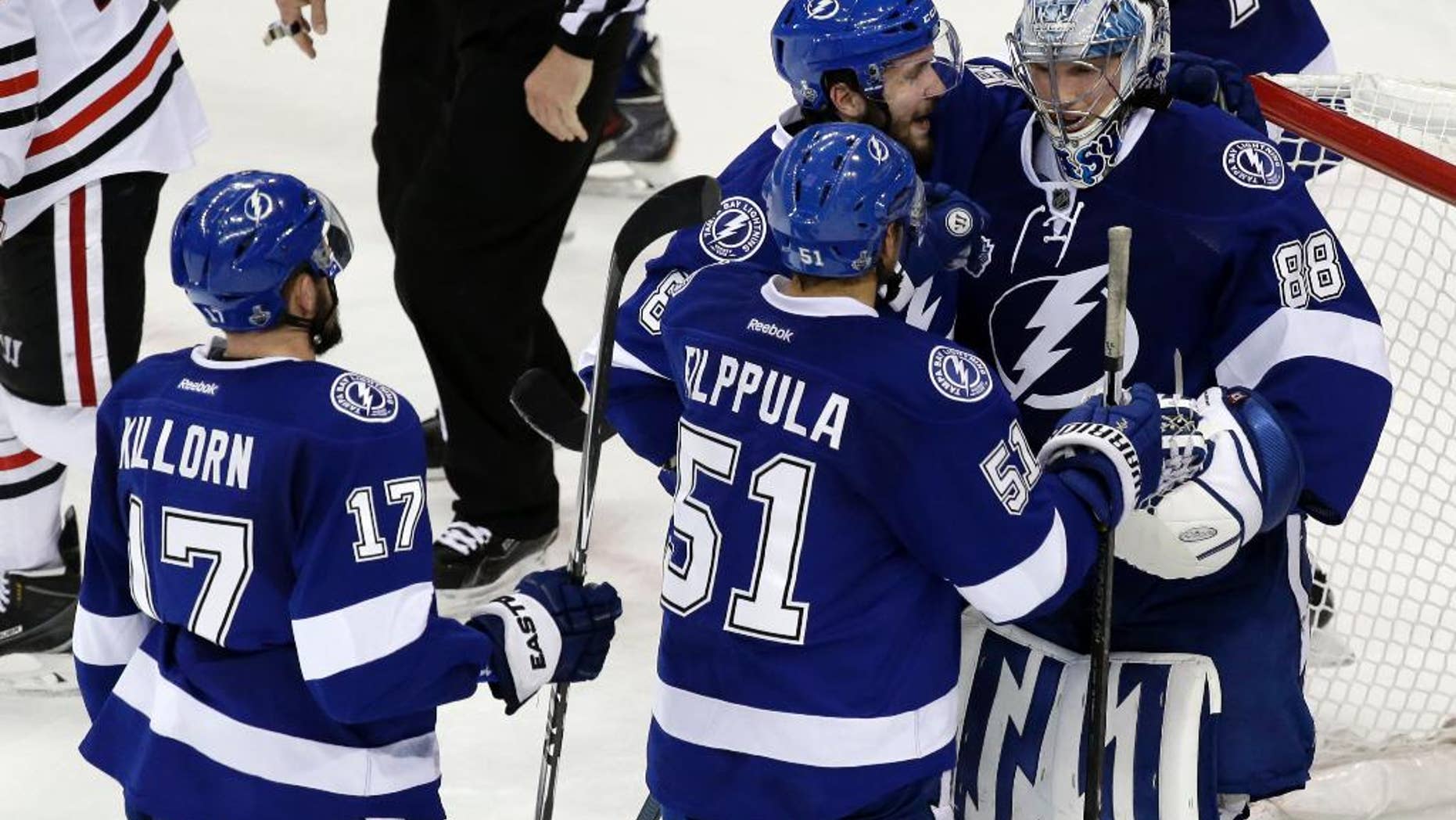 Tampa Bay Lightning players greet backup goalie Andrei Vasilevskiy after their win against the Chicago Blackhawks in Game 2 of the NHL hockey Stanley Cup Final on Saturday, June 6, 2015, in Tampa Fla. (AP Photo/John Raoux)