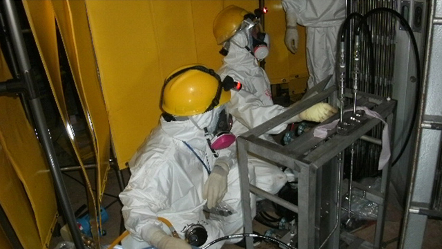 June 3: Workers try to install a pressure indicator inside the Unit 1 reactor at Fukushima Dai-ichi nuclear power plant in Okuma, Fukushima Prefecture, northern Japan.