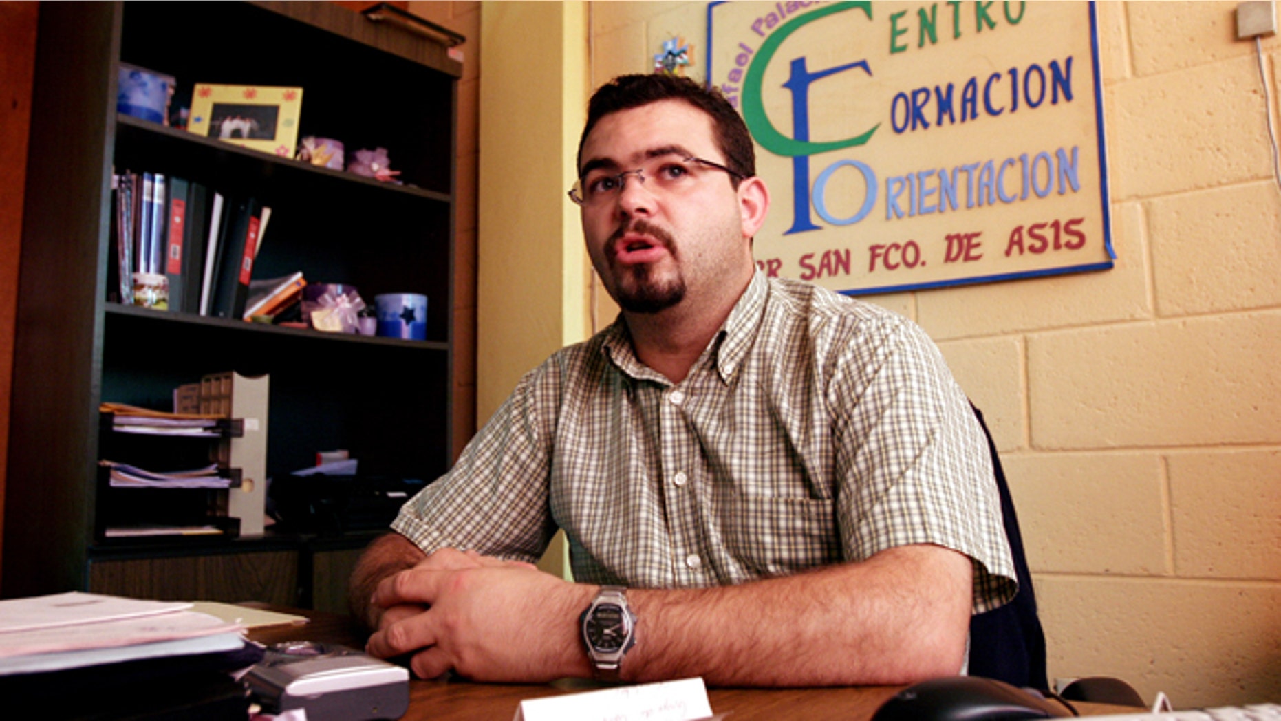 FILE - In this Tuesday Oct. 24, 2006 file photo, Roman Catholic priest Antonio Rodriguez Tercero explains the function of the youth center in the San Salvador suburb Mejicanos, El Salvador. Police in El Salvador arrested the Spanish priest, Wednesday, July 30, 2014, on charges he tried to get favorable treatment for gang members and smuggled contraband into prisons. The priest had been involved in programs aimed at rehabilitating gang members. (AP Photo/Luis Romero, File)