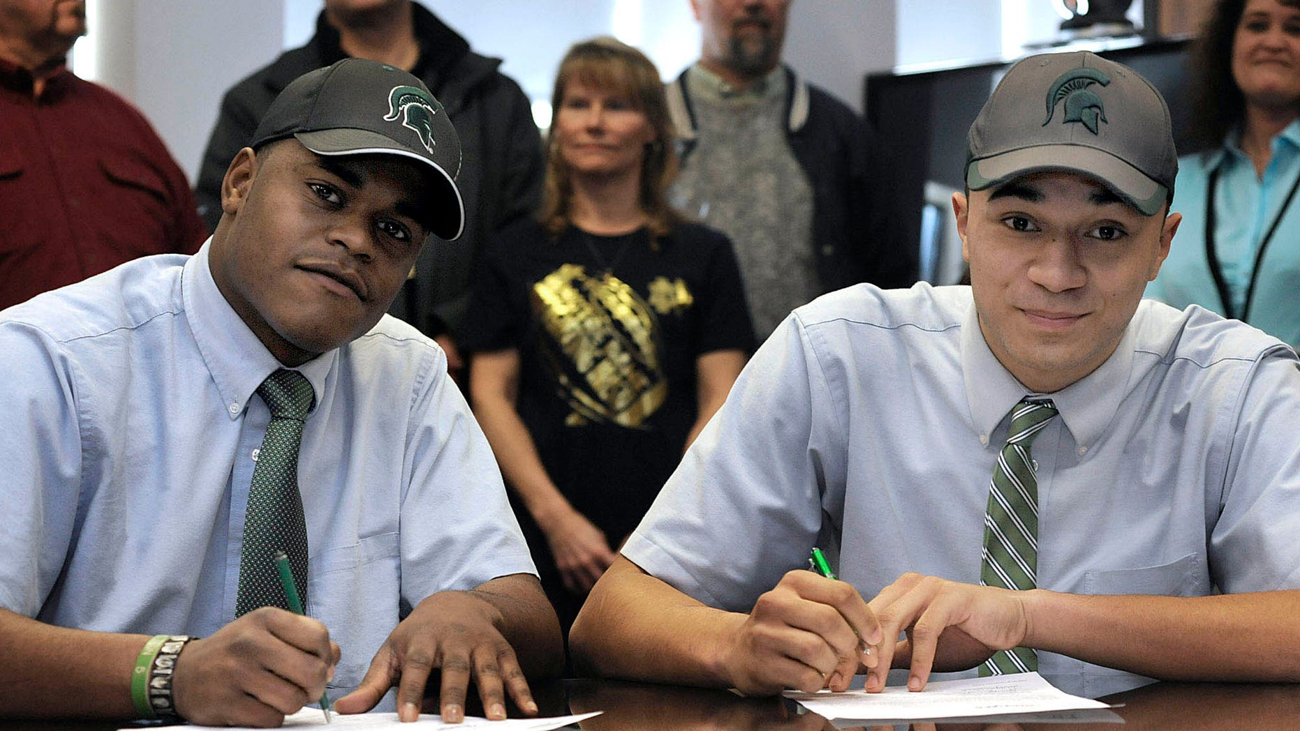 Cathedral Preparatory School seniors Delton Williams, left, and Damion Terry, attend a ceremonial letter-of-intent signing at the school in Erie, Pa., on Wednesday, Feb. 6, 2013. Earlier in the day, they signed their actual letters of intent to attend and play football at Michigan State. (AP Photo/Erie Times-News, Christopher Millette) MAGS OUT, TV OUT