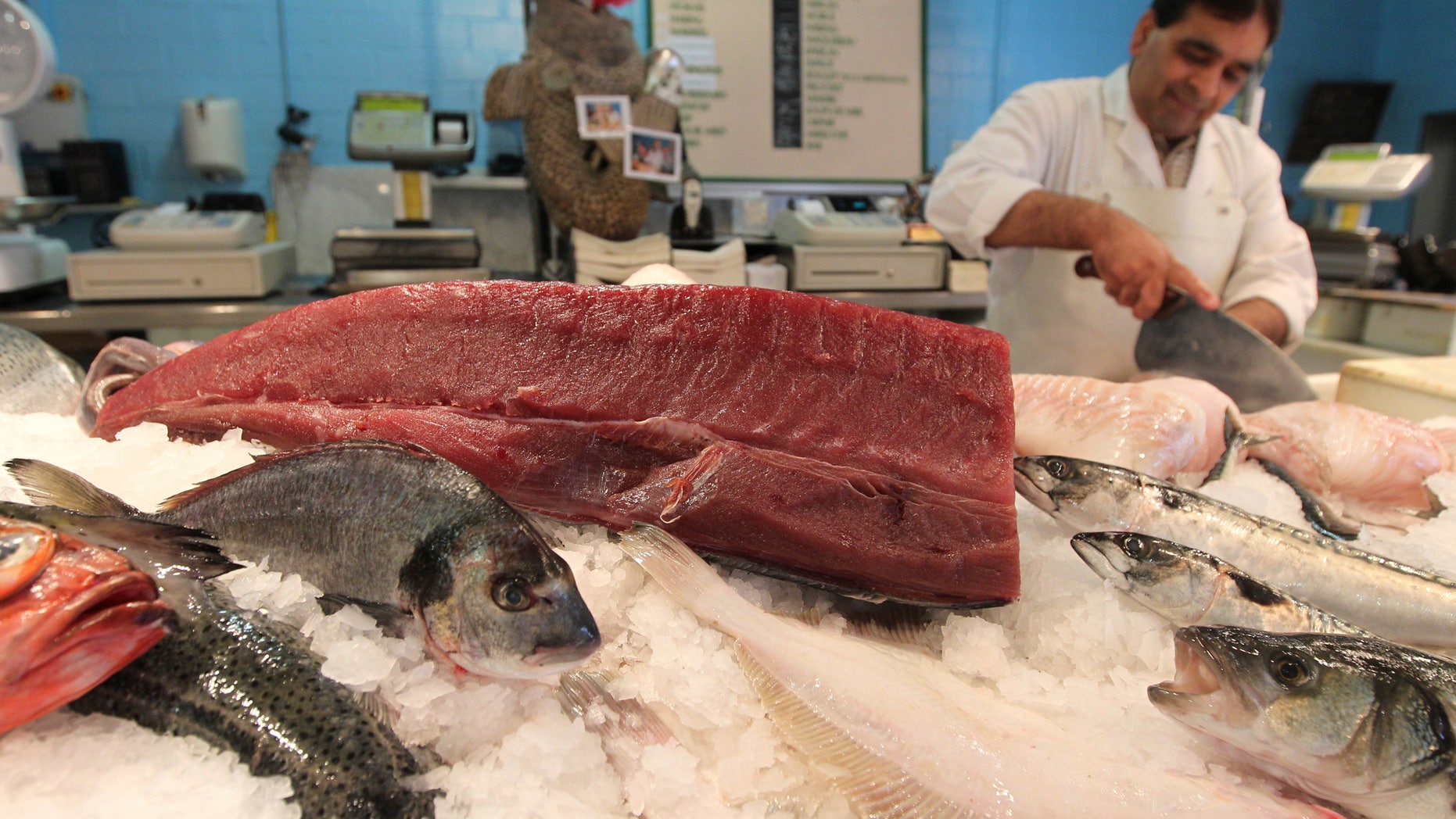 FILE -- In this June 12, 2012 file photo, a piece of yellowfin tuna, top, is displayed at a fish shop in Ghent, Belgium. On Wednesday, Feb. 27, 2013 Officials from the 27 European Union countries approved a proposal on a phased ban on vessels discarding of unwanted fish, but environmentalists are condemning the measure as too weak. The aim is to preserve fish stocks, some of which are dwindling dangerously. (AP Photo/Yves Logghe, File)