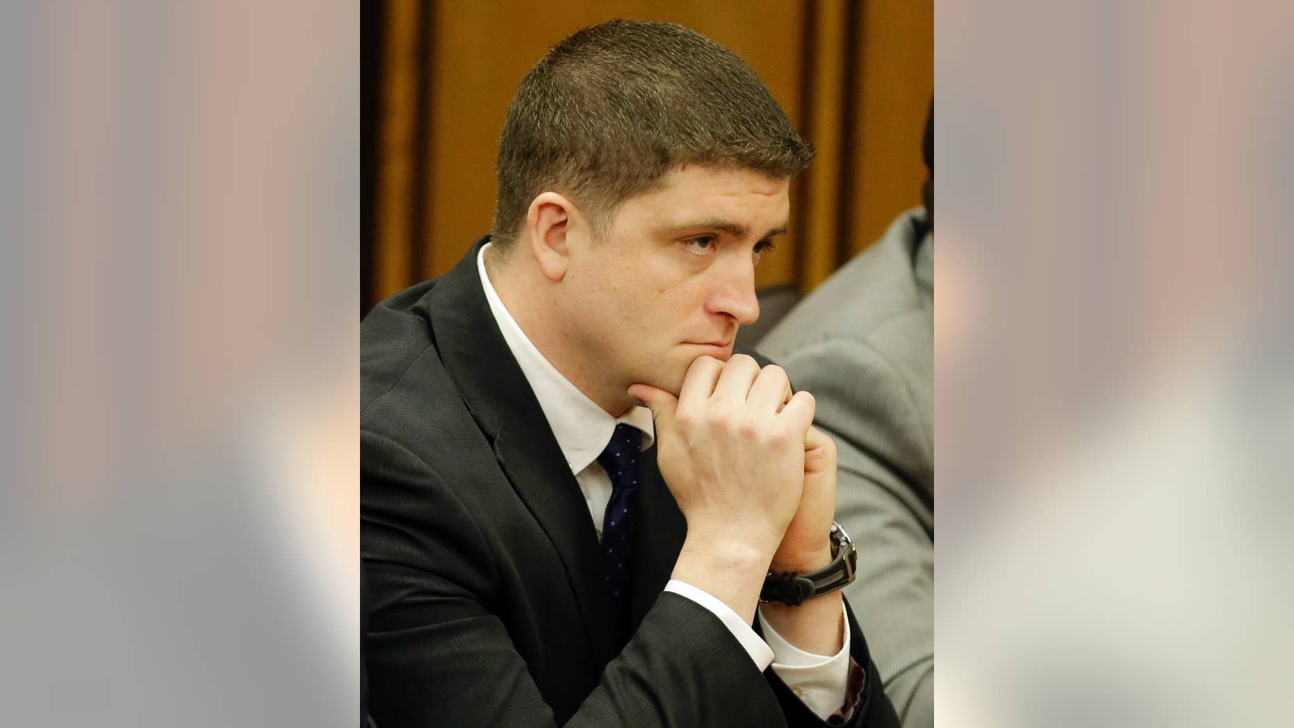 FILE - In this May 23, 2015 file photo, Michael Brelo listens to the judge read his verdict in Cleveland. Brelo, a Cleveland officer found not guilty in the fatal shooting of two people in a 137-shot barrage of police gunfire has been charged with beating up his twin brother four days after his acquittal. A criminal complaint filled Wednesday, June 3, 2015, against 31-year-old Michael Brelo and brother Mark shows the two were charged with attacking each other May 27 in the suburb of Bay Village.(AP Photo/Tony Dejak)