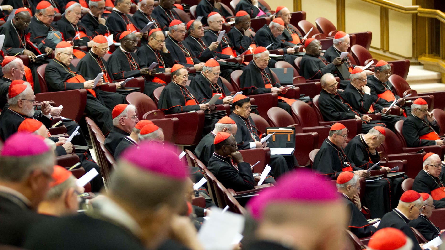Cardinals and bishops listen to Pope Francis' speech as they attend a special consistory, in the Synod hall at the Vatican, Thursday, Feb. 12, 2015. Pope Francis met with cardinals and bishops who will take part in the upcoming Feb. 14, 2015 consistory during which he will elevate 20 new cardinals. Pope Francis is urging his cardinals to cooperate with his reform of the outdated and dysfunctional Vatican bureaucracy, saying the overhaul will help him govern the 1.2-billion-strong Catholic Church better and spread the faith more effectively. Francis summoned cardinals from around the world to hear proposals for revamping the church's central government. The proposals include merging offices and reducing waste. Opening the meetings Thursday, Francis said the aim was to encourage greater harmony and collaboration in "absolute transparency," to help the church spread the faith and reach out to others. (AP Photo/Andrew Medichini)