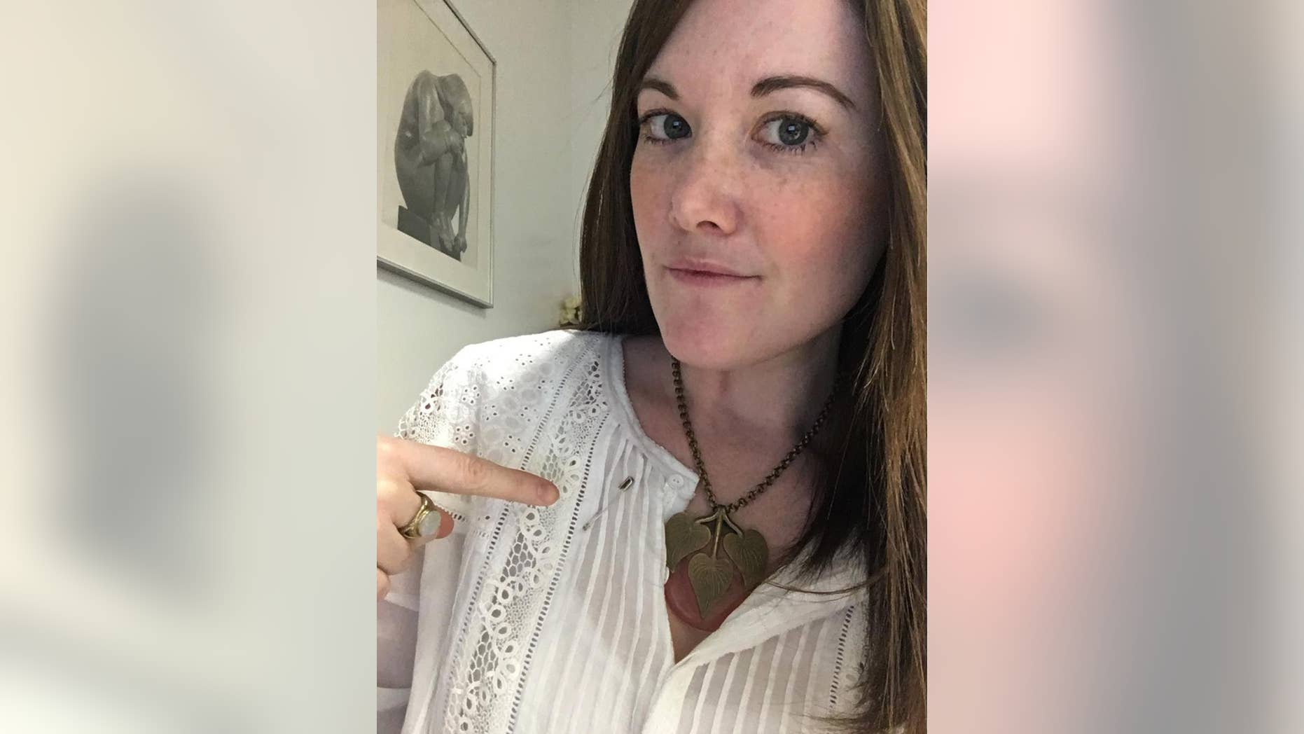 Johanna Dickson, in a selfie, points to a safety pin on her shirt in New York, Monday, Nov. 14, 2016. A “safety pin movement” post-Brexit is offering solidarity to those who fear they’ll be disenfranchised by a Donald Trump presidency. “I chose to be an ally and not be silent,” she wrote on Instagram. (Johanna Dickson via AP)