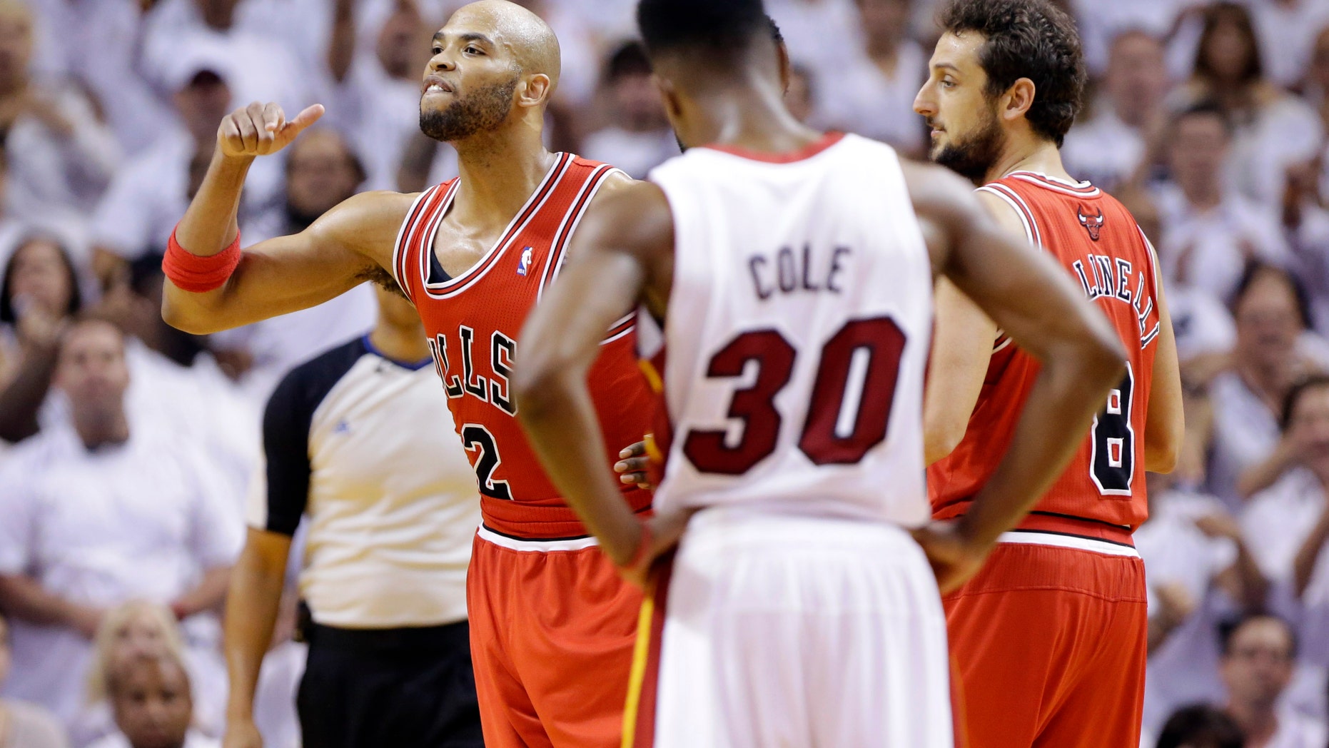 Chicago Bulls forward Taj Gibson, left, reacts after he was ejected during the second half of Game 2 of their NBA basketball playoff series in the Eastern Conference semifinals against the Miami Heat, Wednesday, May 8, 2013, in Miami. Chicago's Marco Belinelli and Miami's Norris Cole (30) stand by. The Heat won 115-78. (AP Photo/Lynne Sladky)