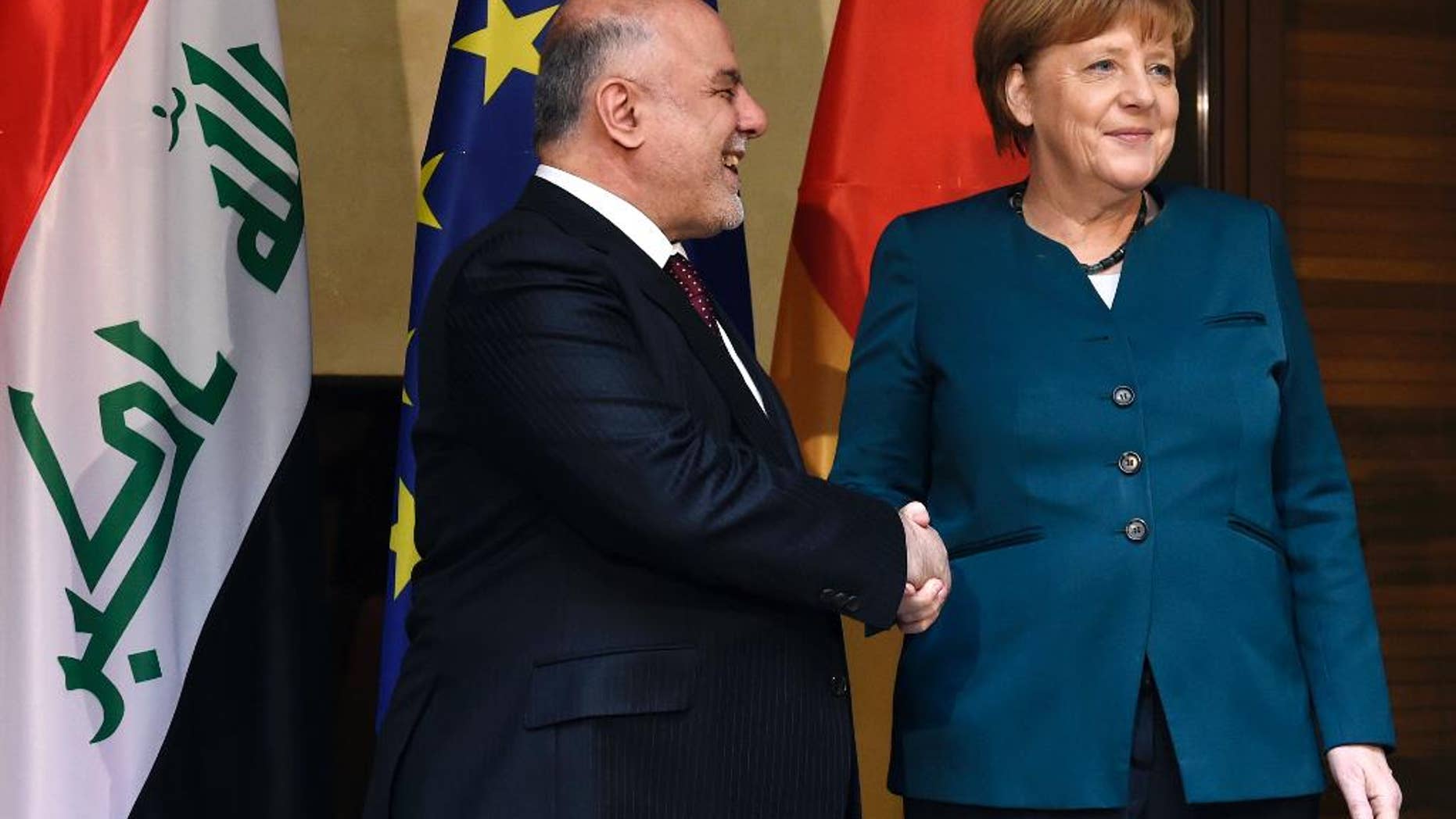 German Chancellor Angela Merkel, right, shakes hands with the Prime Minister of Iraq Haider al-Abadi for the media ahead of bilateral talks during the Munich Security Conference in Munich, Germany, Saturday, Feb. 18, 2017. The annual weekend gathering is known for providing an open and informal platform to meet in close quarters. (Christof Stache/Pool via AP)