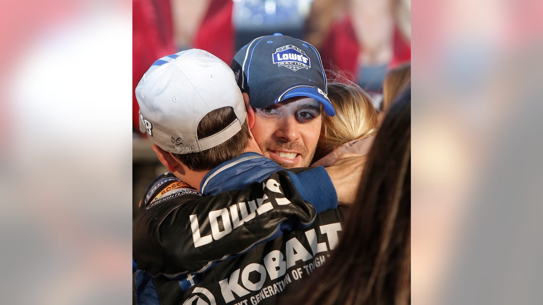 Jimmie Johnson hugs his crew in victory lane after winning the NASCAR Sprint Cup series auto race at Texas Motor Speedway in Fort Worth, Texas, Sunday, Nov. 3, 2013. (AP Photo/Brandon Wade)