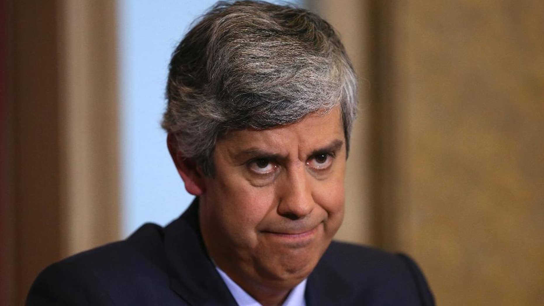 FILE- In this Friday, Feb. 5 2016 file photo, Portuguese Finance Minister Mario Centeno listens to journalists' questions during the presentation of his government's 2016 state budget, at the finance ministry in Lisbon. After calling a news conference to explain his widely criticized handling of a state-owned bank appointment, Centeno earned public statements of support from the prime minister and president, Tuesday, Feb. 14, 2016. (AP Photo/Armando Franca, File)