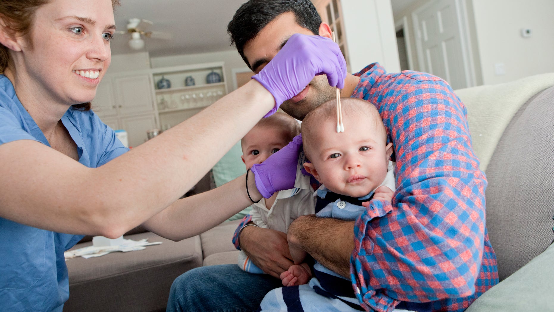 Jan. 29, 2016: This image shows NYU senior research coordinator Nora Henderson collecting samples of bacteria from twin boys at their Mamaroneck, N.Y., home.