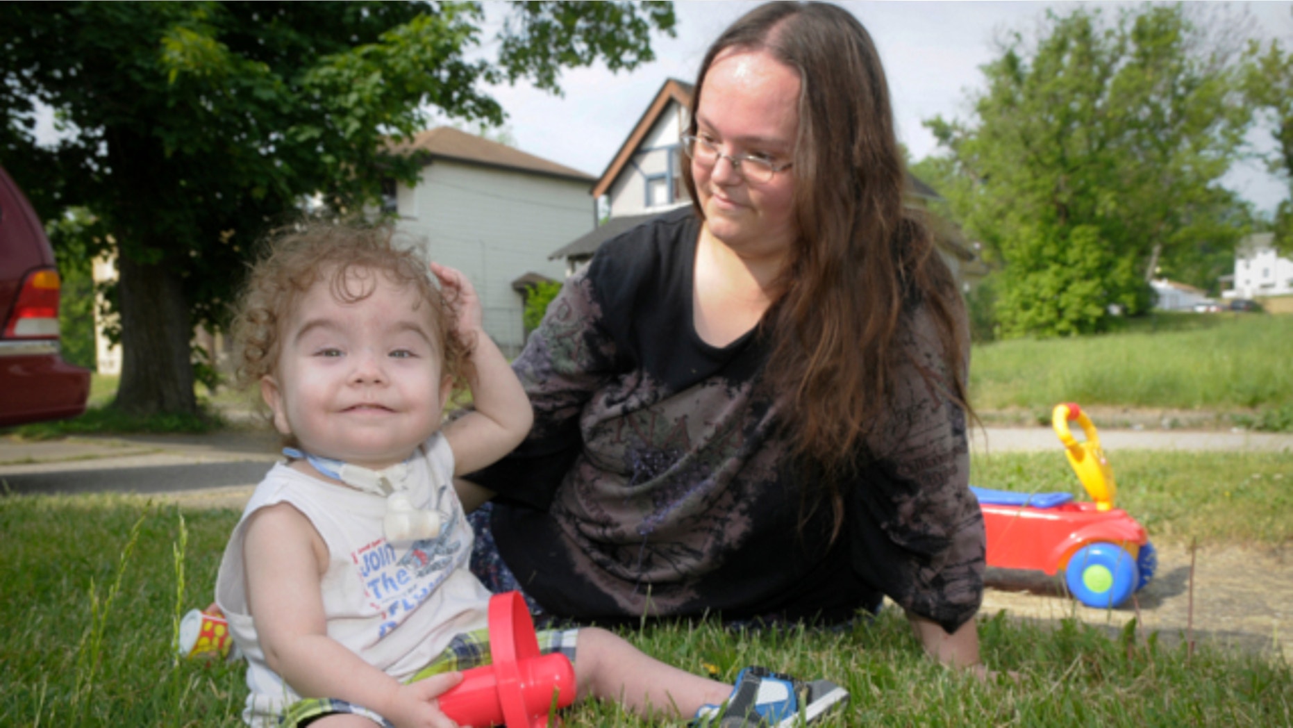 May 21, 2013: Kaiba Gionfriddo plays with his mother, April outside his Youngstown, Ohio home.