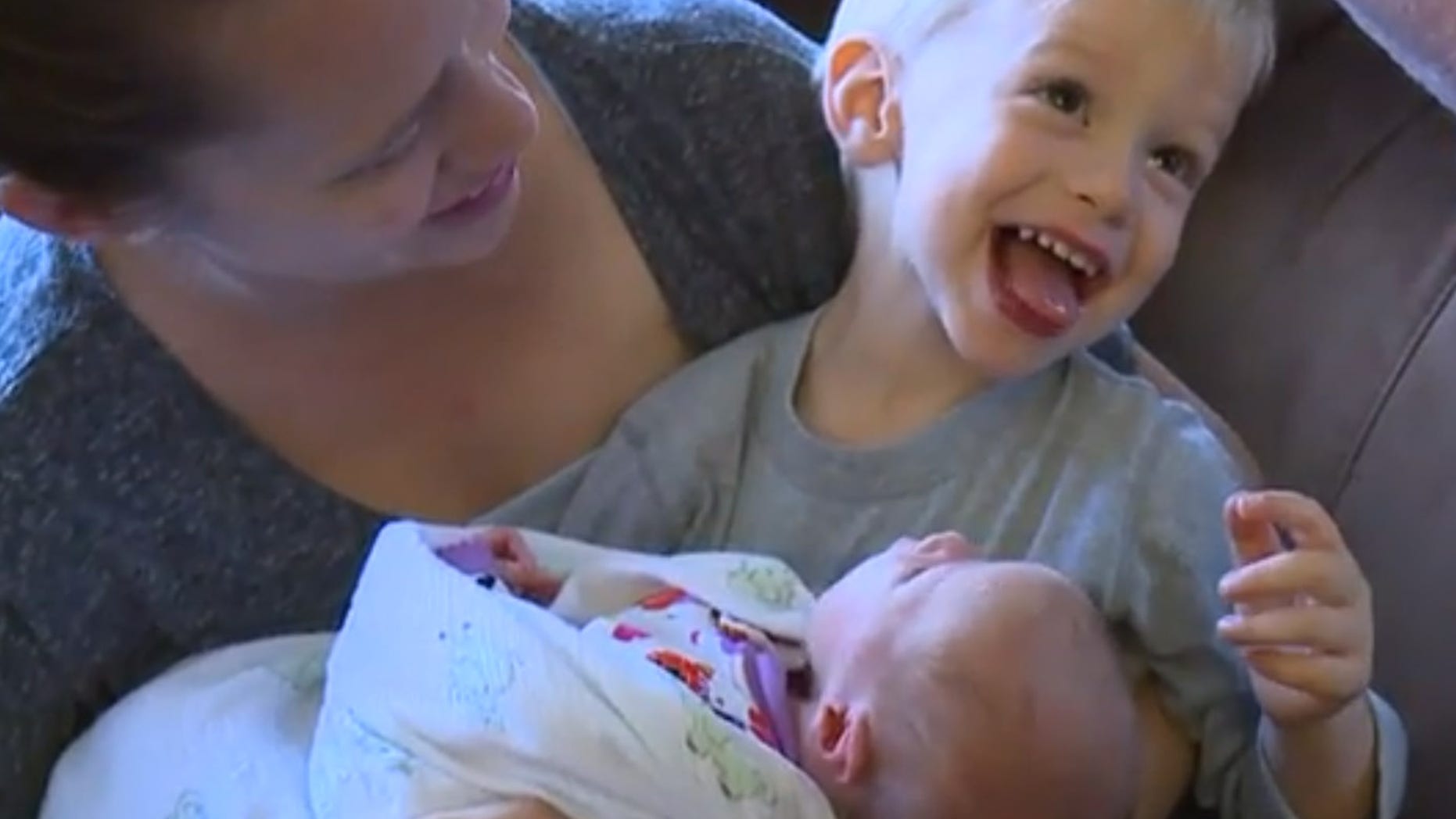 Baby Ella, pictured with her mother and older brother, was born in the family's car outside of the hospital's emergency room.