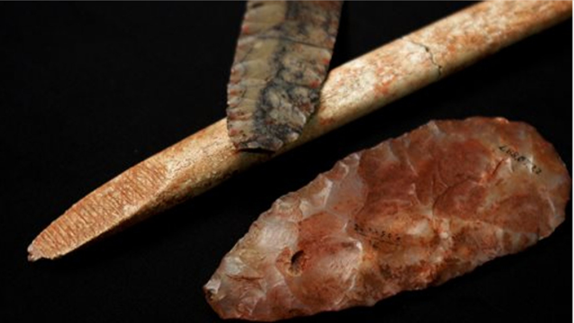UNDATED: This photo provided by researcher Sarah L. Anzick shows a nearly-complete projectile point, top, a mid-stage point made of translucent quartz and an end-beveled rod of bone from a Clovis-era burial site found in 1968 in western Montana.