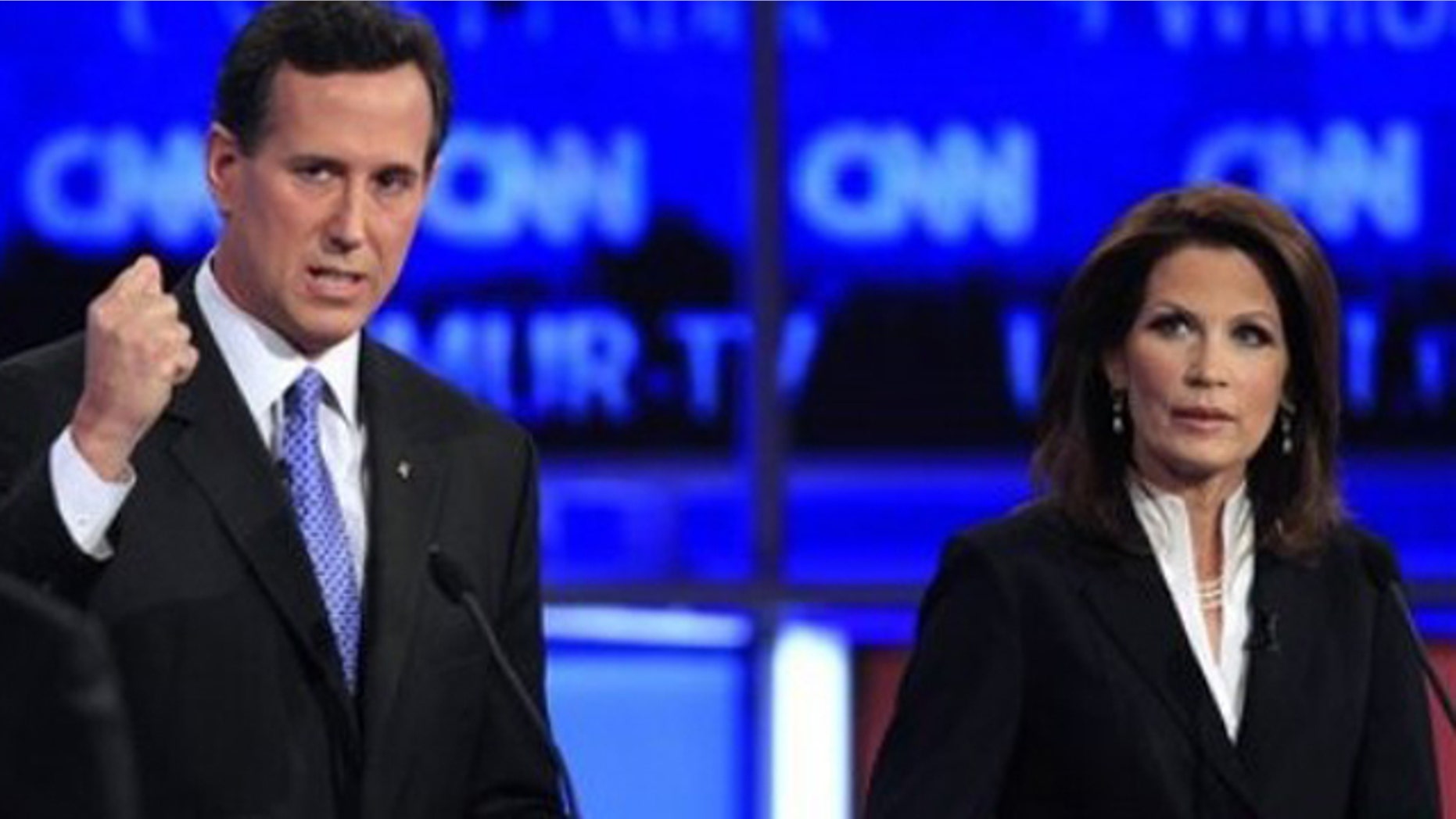 Former Pennsylvania Sen. Rick Santorum answers a question from CNN's John King, left, as Rep. Michele Bachmann, R-Minn., right, listens during the first New Hampshire Republican presidential debate at St. Anselm College in Manchester, N.H., Monday, June 13, 2011. (AP Photo/Jim Cole)