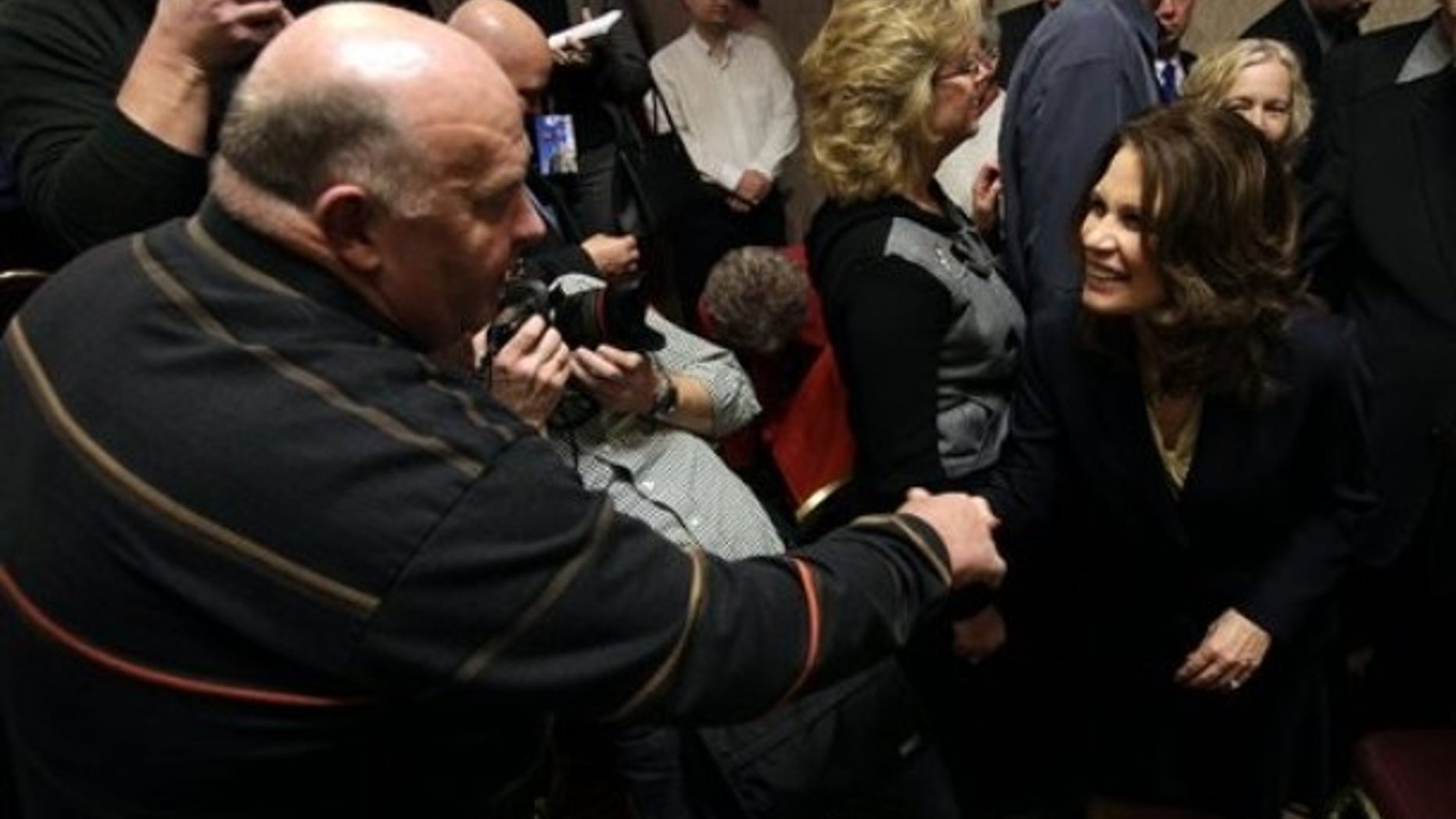In this Jan. 21, 2011 file photo, U.S. Rep. Michele Bachmann, R-Minn. , greets Jim Ervin, of Urbandale, Iowa, left, after speaking at a reception by the Iowans for Tax Relief in Des Moines, Iowa. (AP)